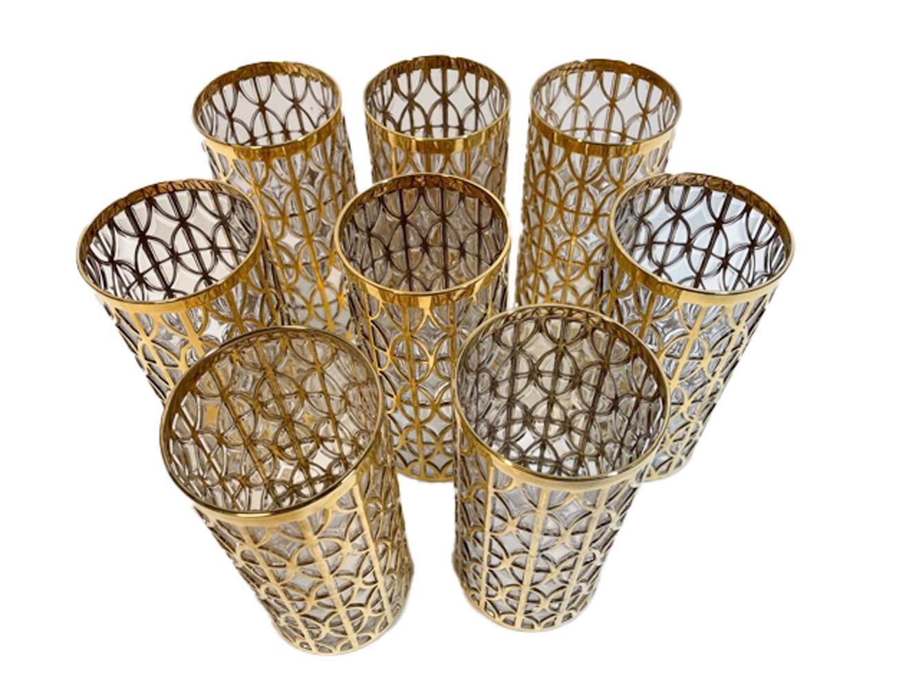 Set of 8 Mid-Century Modern highball glasses made by Imperial Glass Co. in the Tabique de Oro Pattern. Each piece is molded with a raised pattern, the raised areas are then gilded in 22k gold.