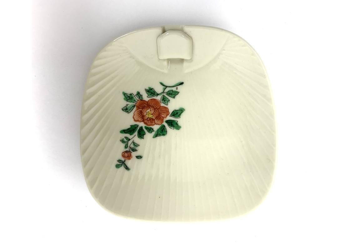 A colorful and fine set of Japanese Canapé Plates in unused condition dating to the Mid 20th Century. The plates in ribbed fan form with three different Flower decorations and having an overlaid slot to hold the tiny plastic and metal Canapé forks.