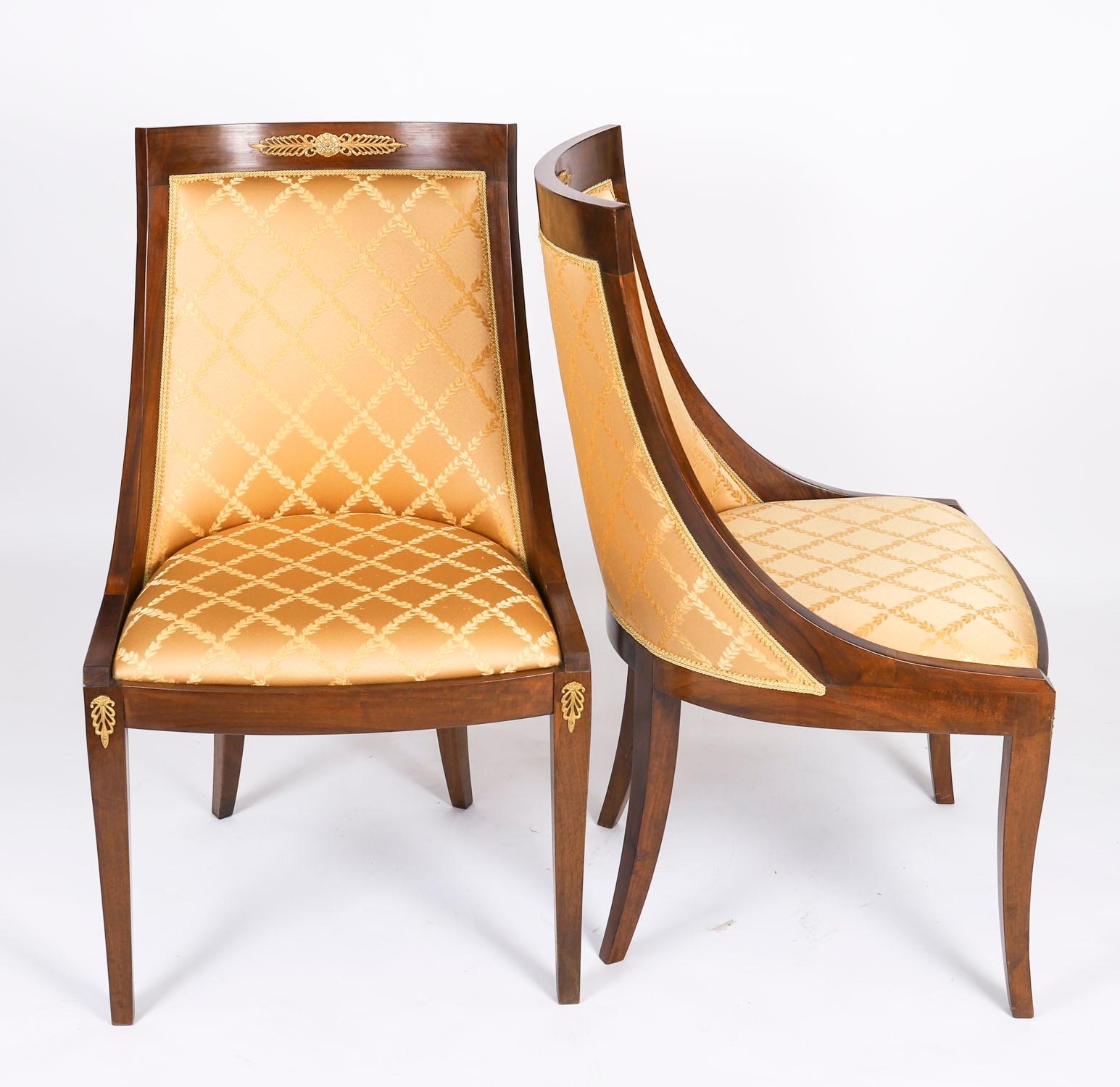 An absolutely fantastic vintage set of four Empire Revival Gondola side / dining chairs, dating from the second half of the 20th Century.

The chairs are made from solid walnut that is beautiful in colour and has been embellished with