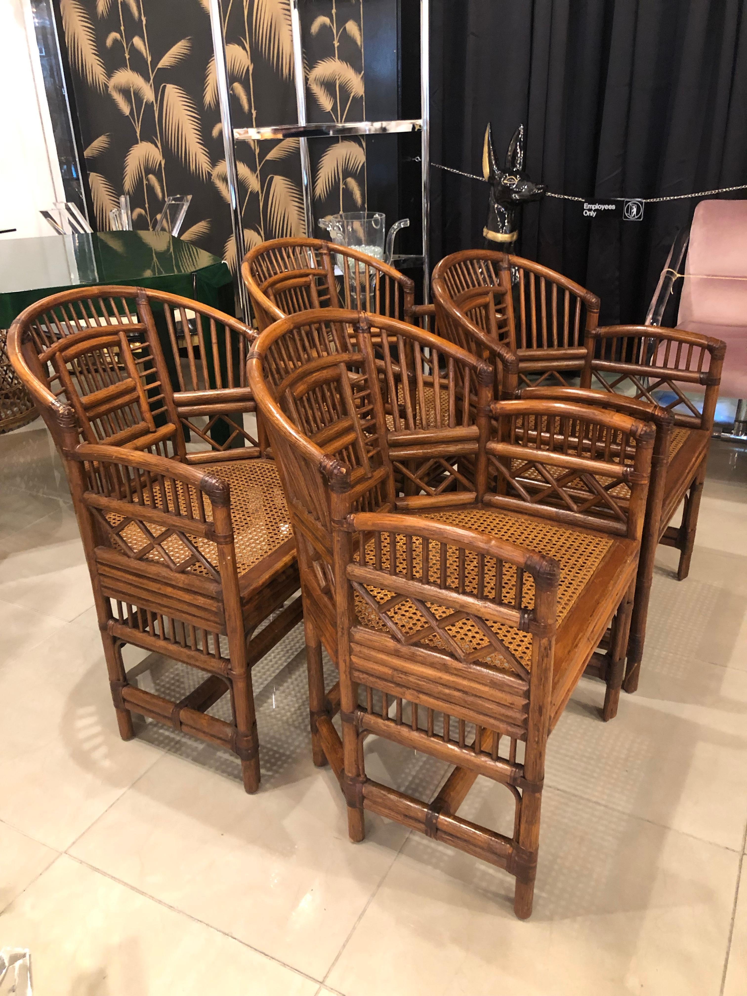 Vintage set of 4 Brighton style rattan, Chinese Chippendale arm dining chairs. No breaks or missing pieces.