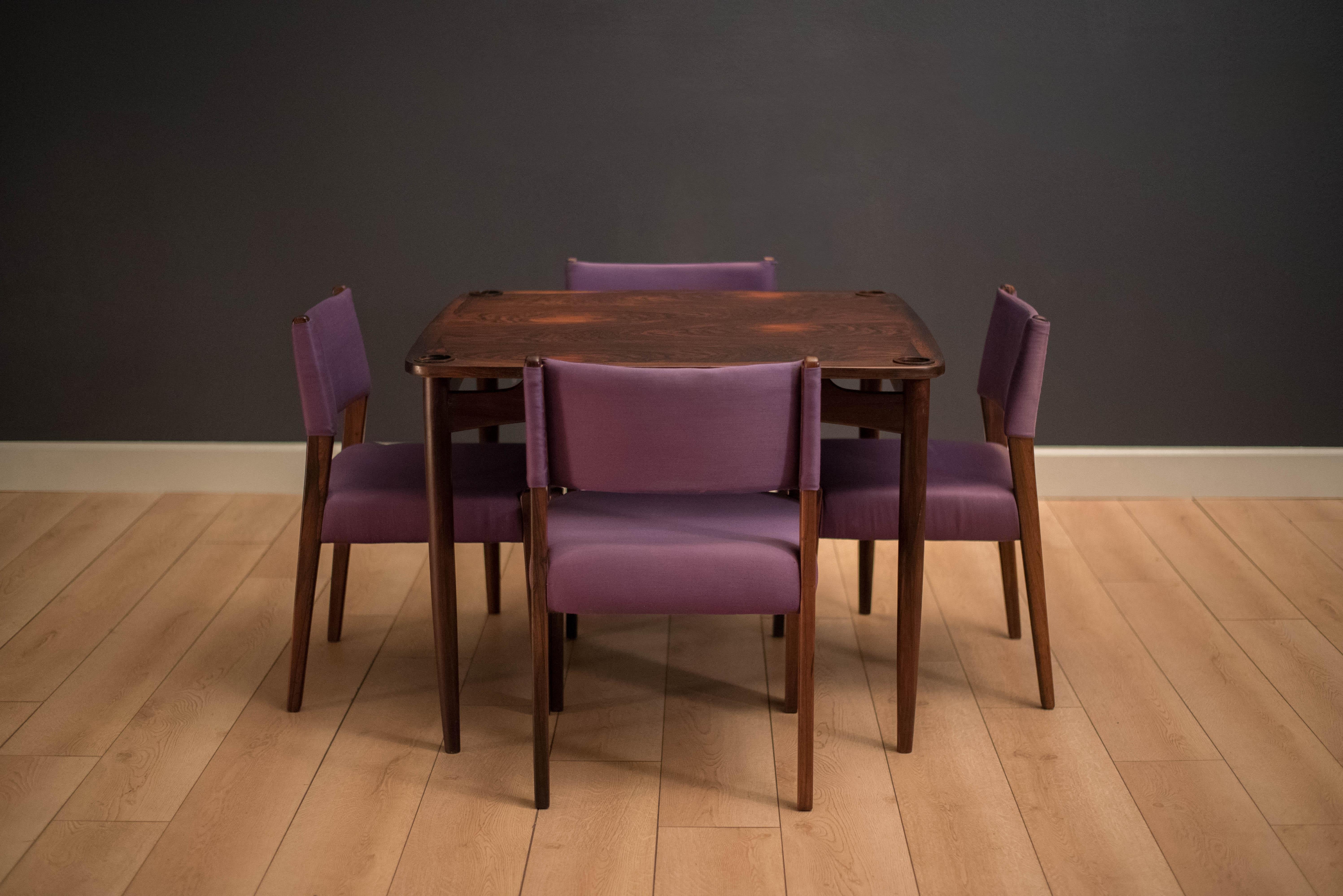 Mid-Century Modern dining chairs in rosewood designed by Sergio Rodrigues for Oca, Brazil. This set includes four chairs with the original fabric. Upholstery can be customized to your choice of fabric at an additional cost. Inquire for more details.