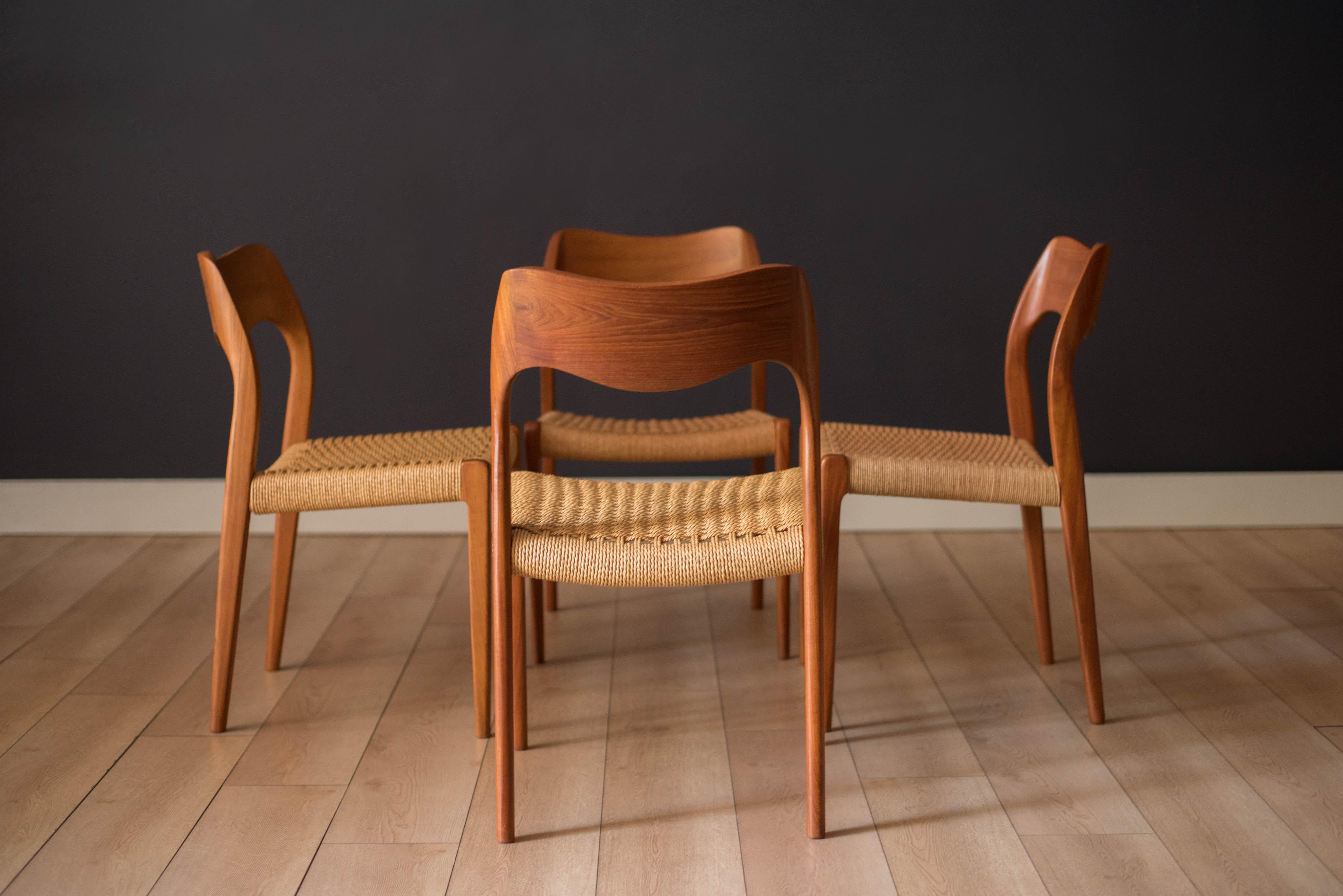 Mid Century Modern dining chairs by Niels O. Møller for J.L. Møller Møbelfabrik model no. 71, Denmark. This set features sculpted teak frames and retains the original paper cord seats. Price is for the set of four.