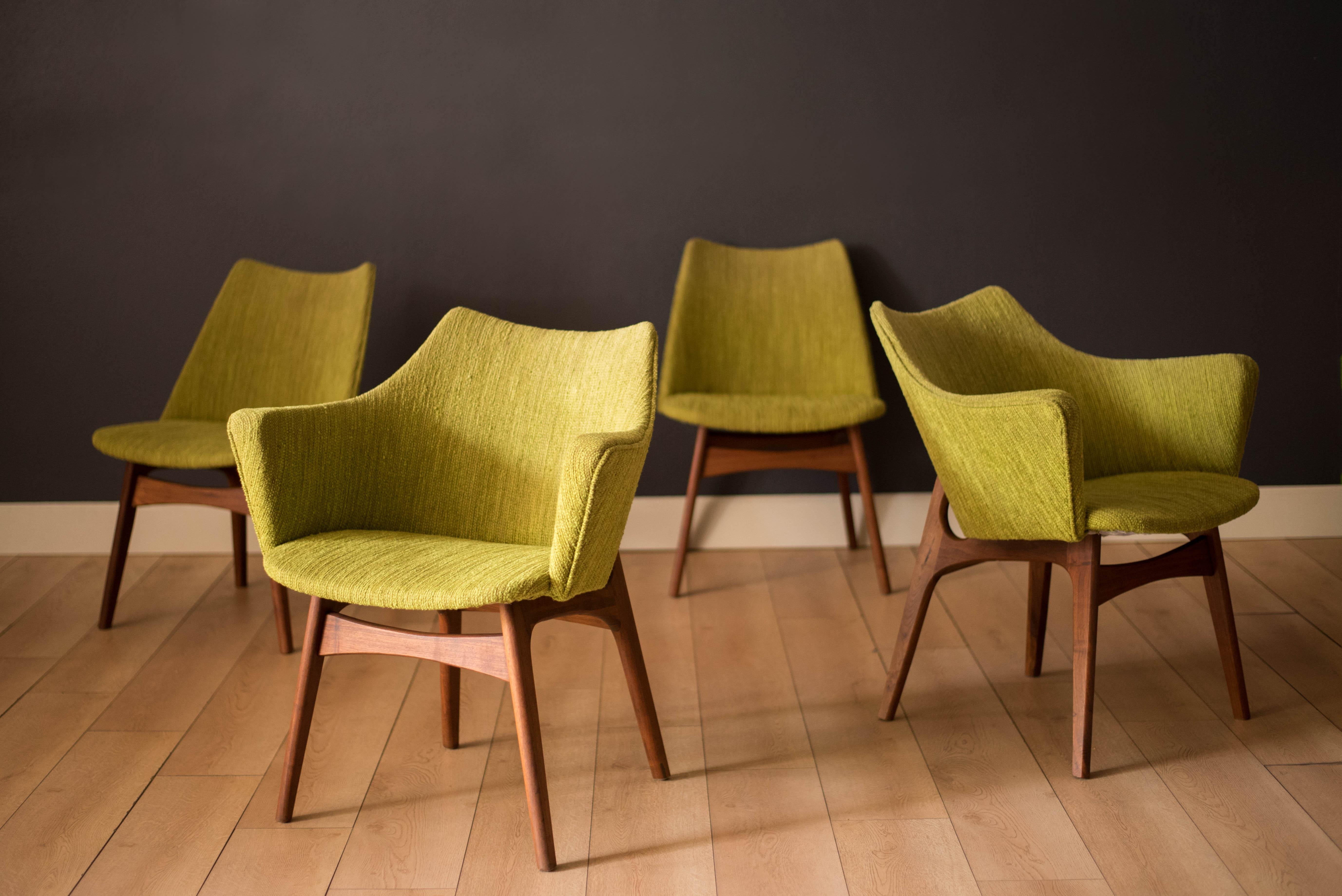 Mid Century Modern set of four dining chairs designed by Adrian Pearsall for Craft Associates. Features sculptural walnut bases and molded plywood backrest frames in the original chartreuse green tweed fabric. Includes two model no. 2418-C armchairs