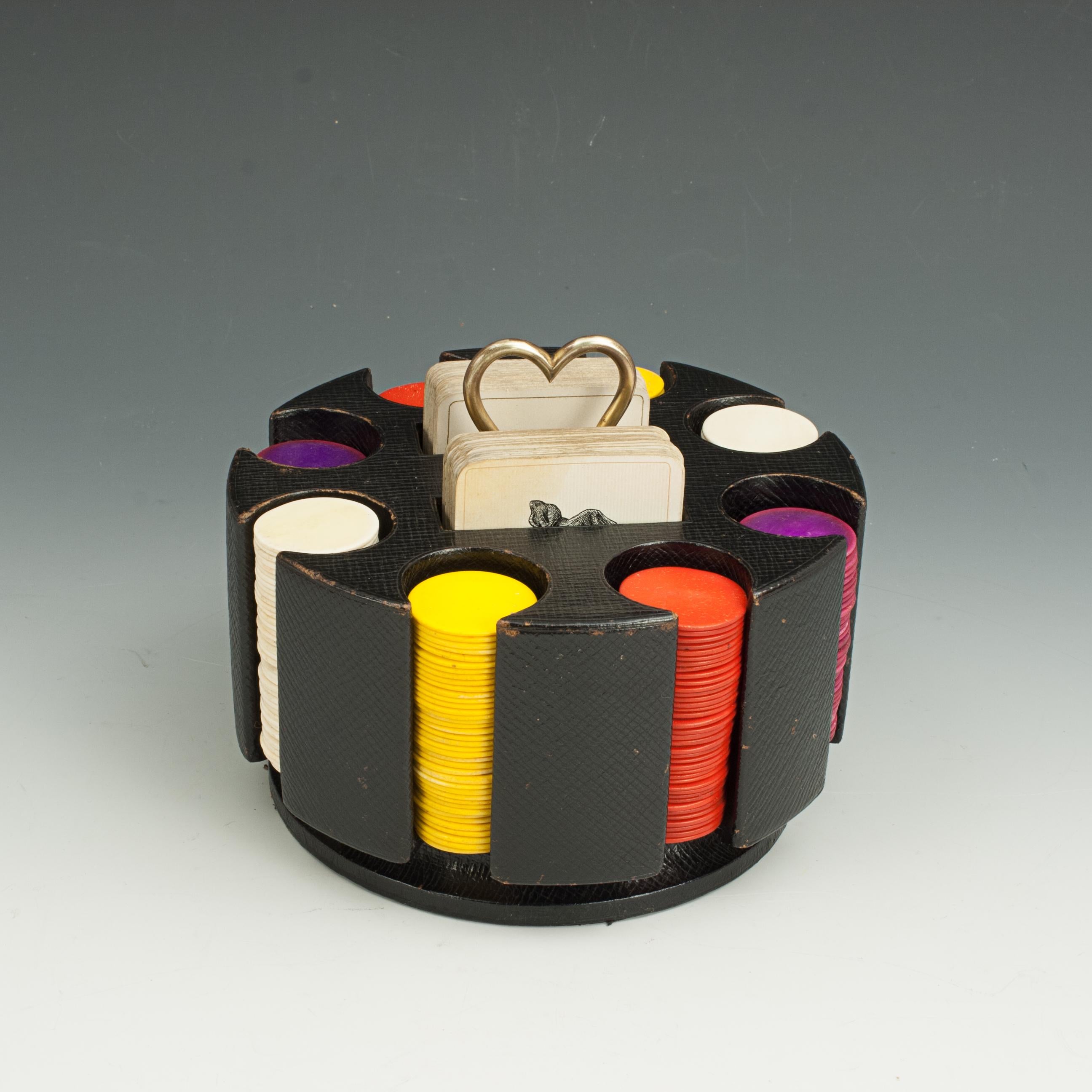 Revolving antique poker chip carousel.
A nice set of gambling counters in a revolving keeper. The carrier contains eight individual circular slots containing coloured gaming chips (74 red, 78 yellow, 79 white and 72 purple/blue) and two slots with