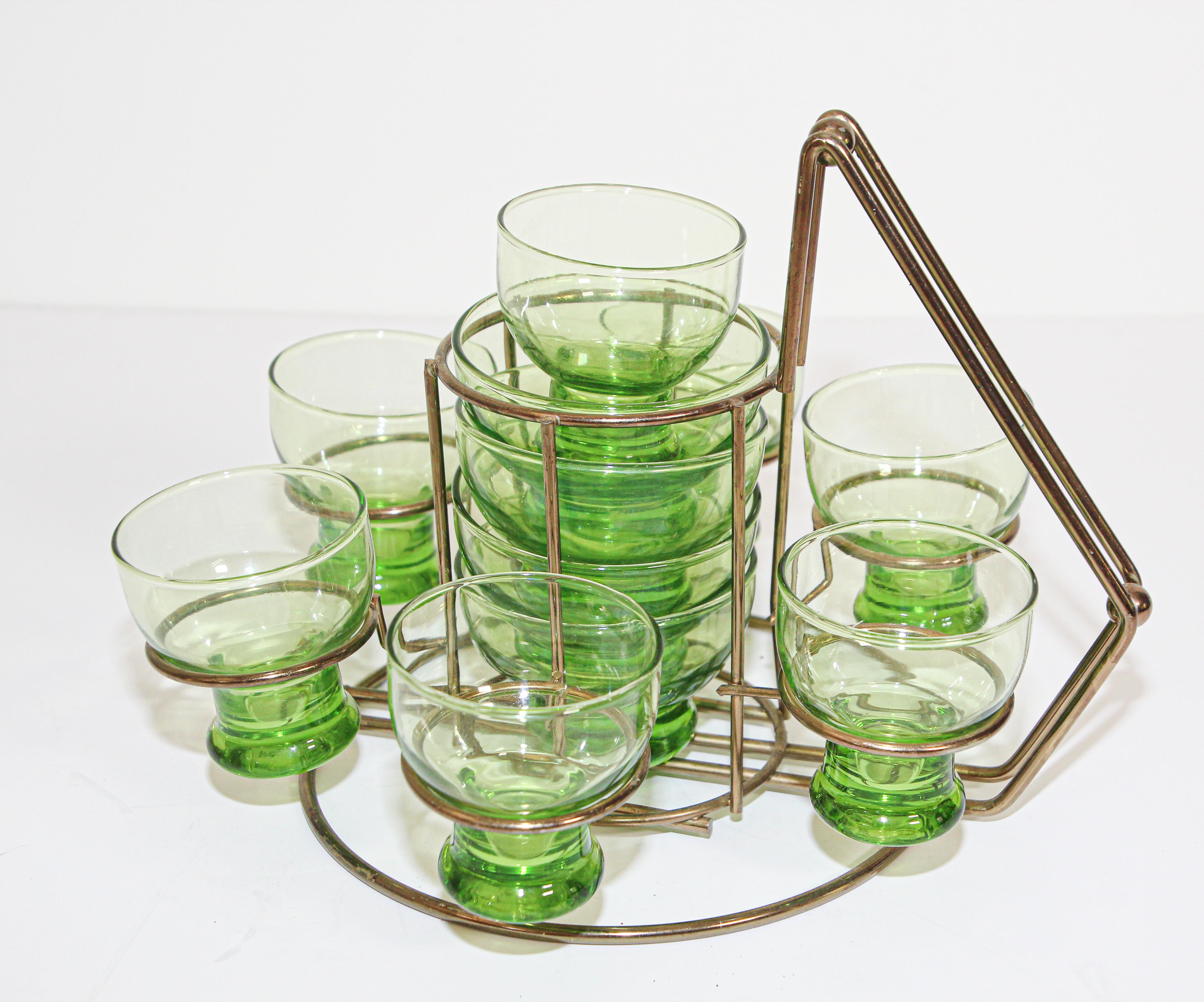 Elegant exquisite vintage set of green cocktail glasses circa 1960s presented in a metal brass cart.
Fantastic midcentury glasses in excellent vintage condition with original accompanying carrying tray.
7 small glasses: Size: 3
