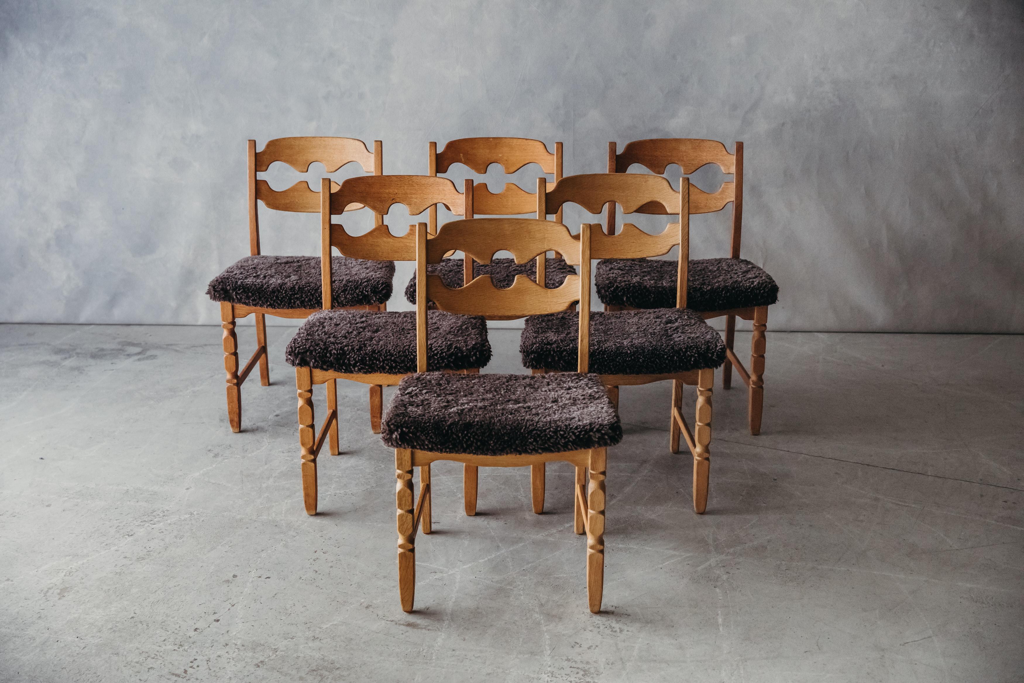 Vintage Set Of Henning Kjaernulf 'Razor' Dining Chairs From Denmark, 1960s. Solid oak construction, later upholstered seats in grey shearling. 

We don't have the time to write an extensive description on each of our pieces. We prefer to speak