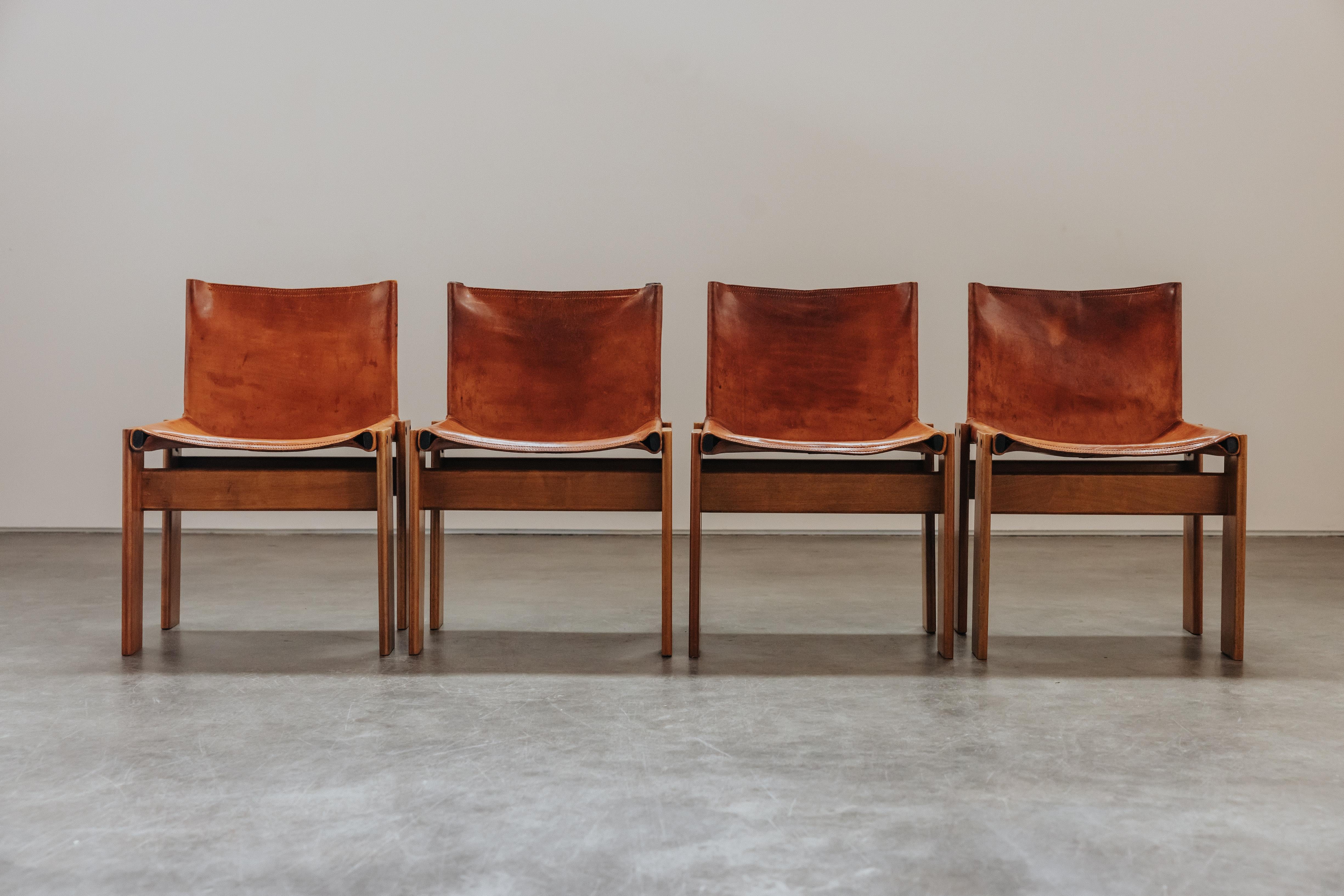 Vintage Set Of Monk Dining Chairs by Afra & Tobia Scarpa for Molteni, 1970s.  Original cognac leather with fantastic patina and use.  One chair with a small tear on seat.