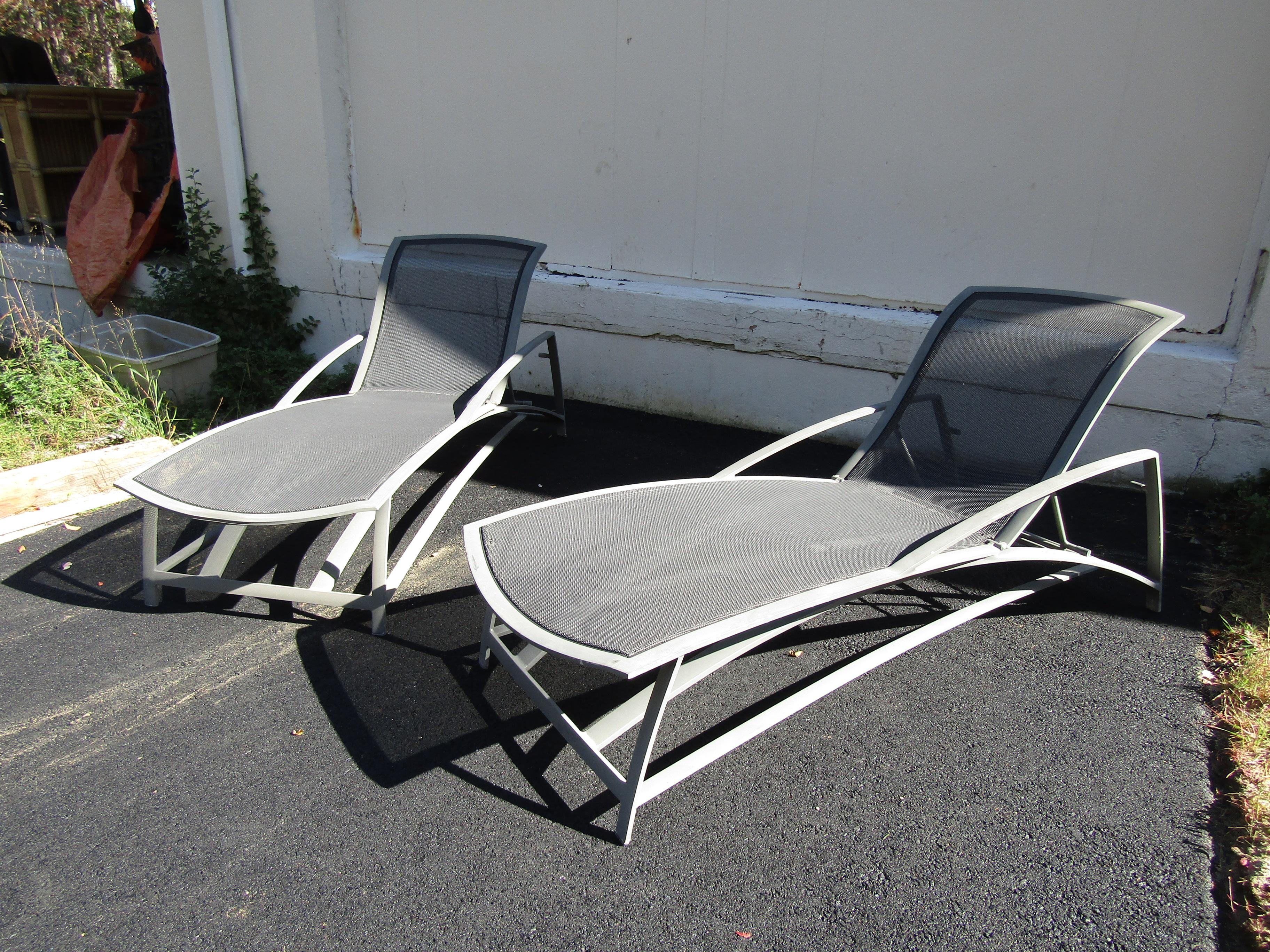 A beautiful set of aluminum outdoor furniture by Jordan Brown. This set includes a glass top coffee table, two lounge chairs, a dining table, four dining chairs, a set of two nesting tables, and two adjustable chaise lounges. Extremely stylish and