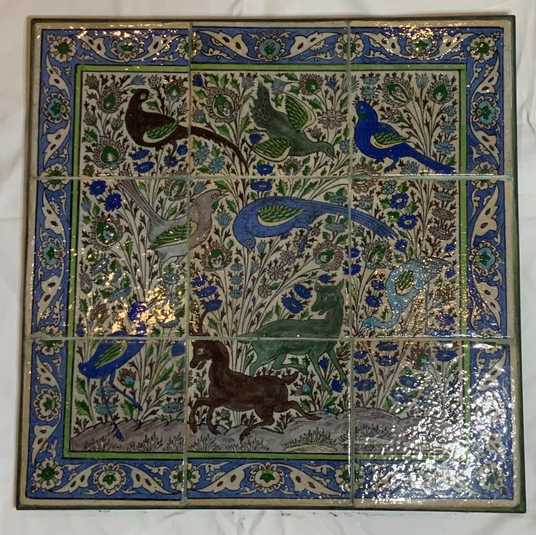 Beautiful set of nine tiles made of hand painted and glazed ceramic, embedded in professionally custom made steel frame. The tiles are painted with birds and animals motifs and floral and vine in the background. Exceptional blue border. One of a