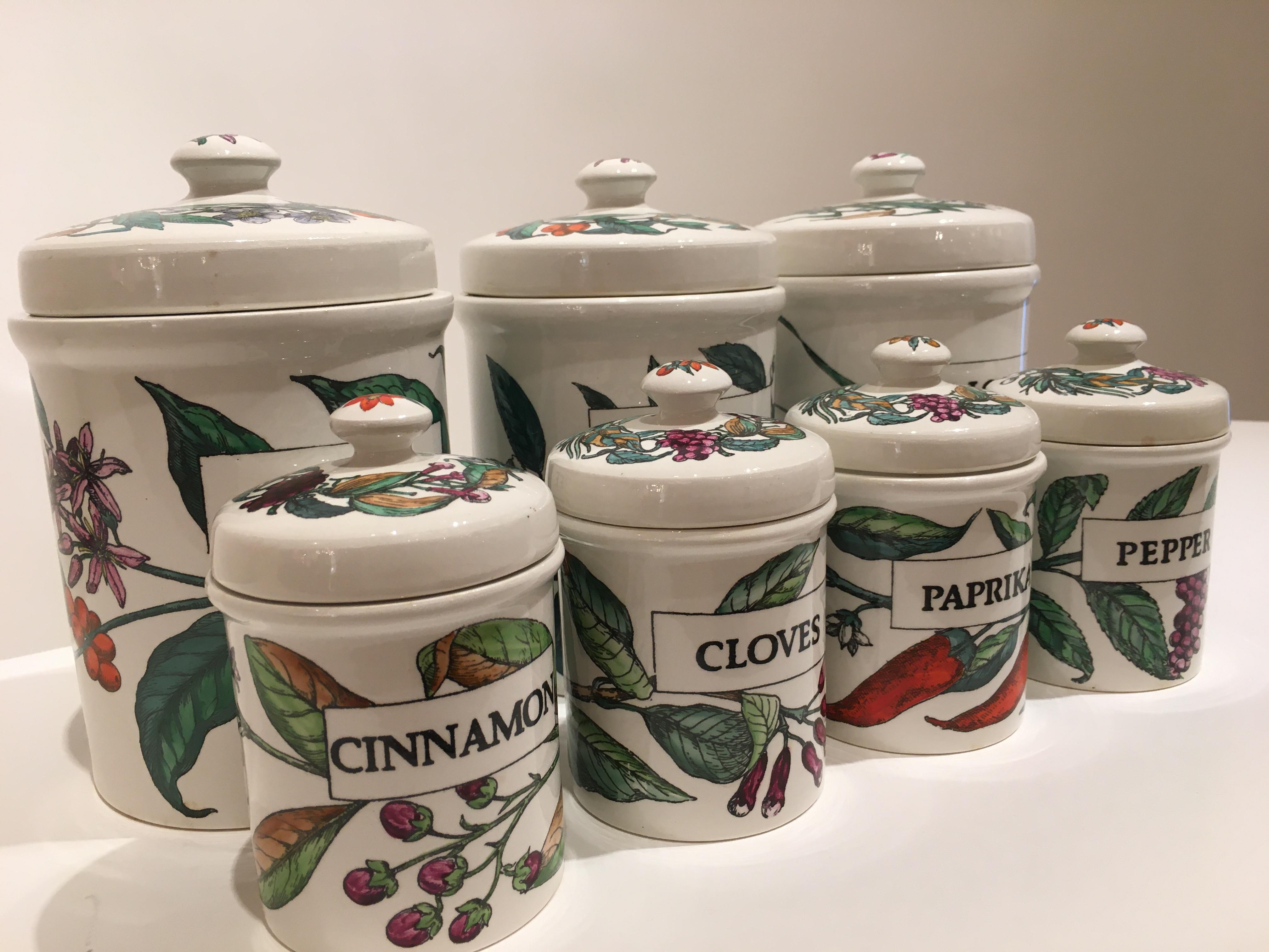 A rare set of beautifully colored decorative ceramic storage jars by Piero Fornasetti, circa 1960. Depicting seven different designs... tea, coffee, rice, paprika, cloves, cinnamon and pepper, these vintage jars were produced using decorative