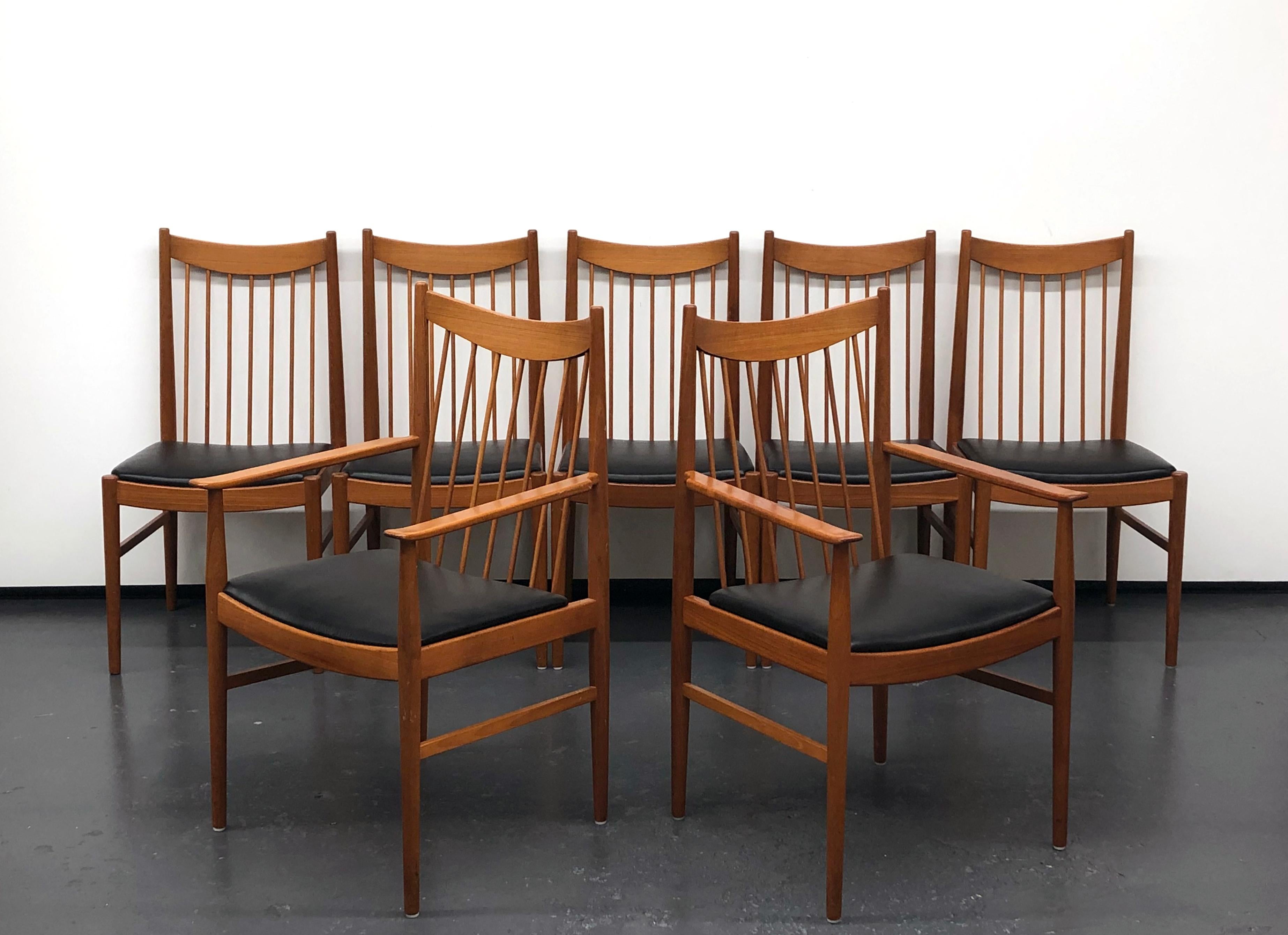 Beautiful set of seven dining chairs by Arne Vodder for Sibast, Denmark. Solid teak wood construction with original black vinyl seating. There are two arm chairs and five side chairs. Each chair is marked with the Sibast foil label.