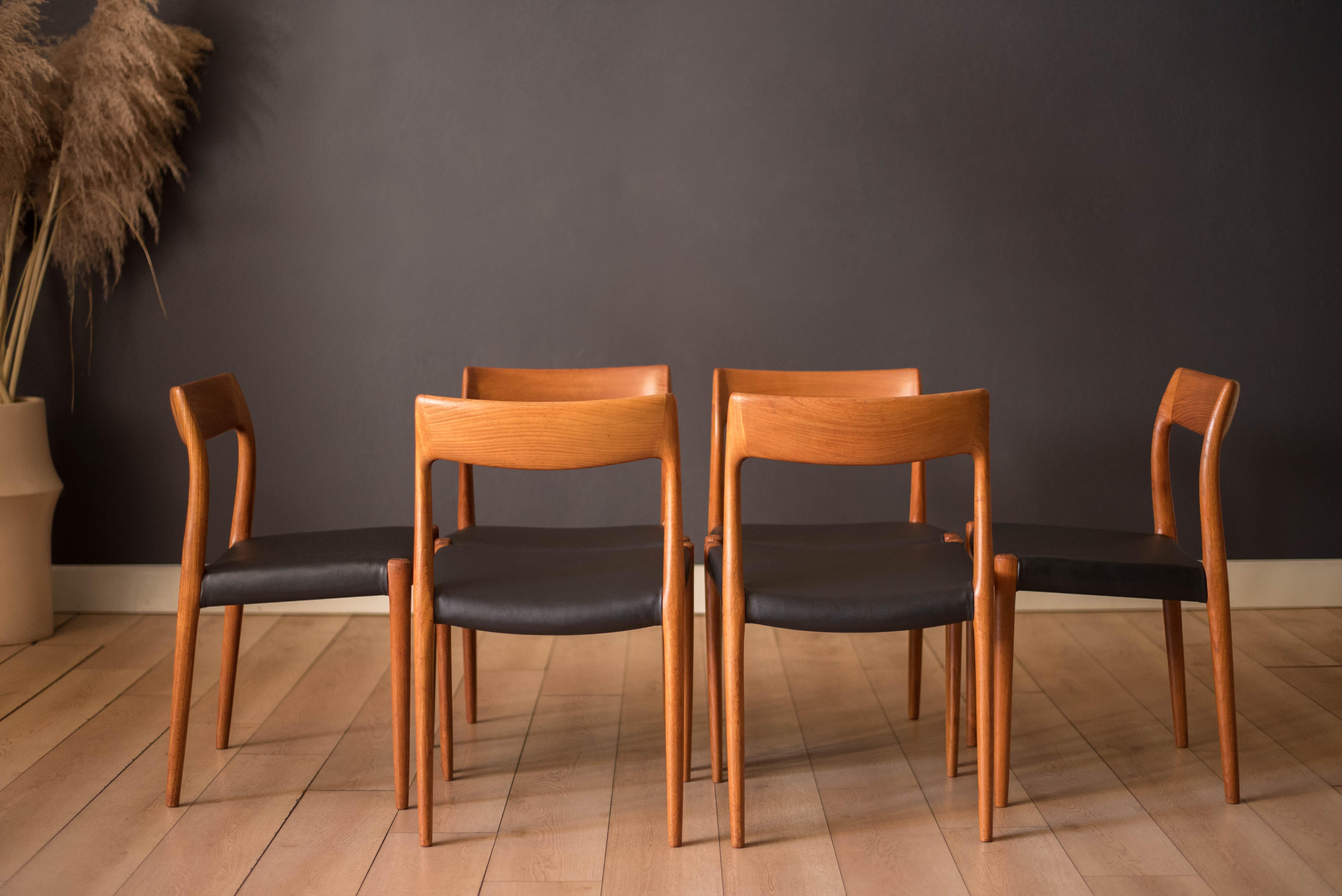 Mid century modern dining chairs model no. 77 designed by Niels Otto Møller for J.L. Møller Møbelfabrik in teak, Denmark. Features sculptural teak frames and black vinyl seats. Price is for the set of six chairs. 



