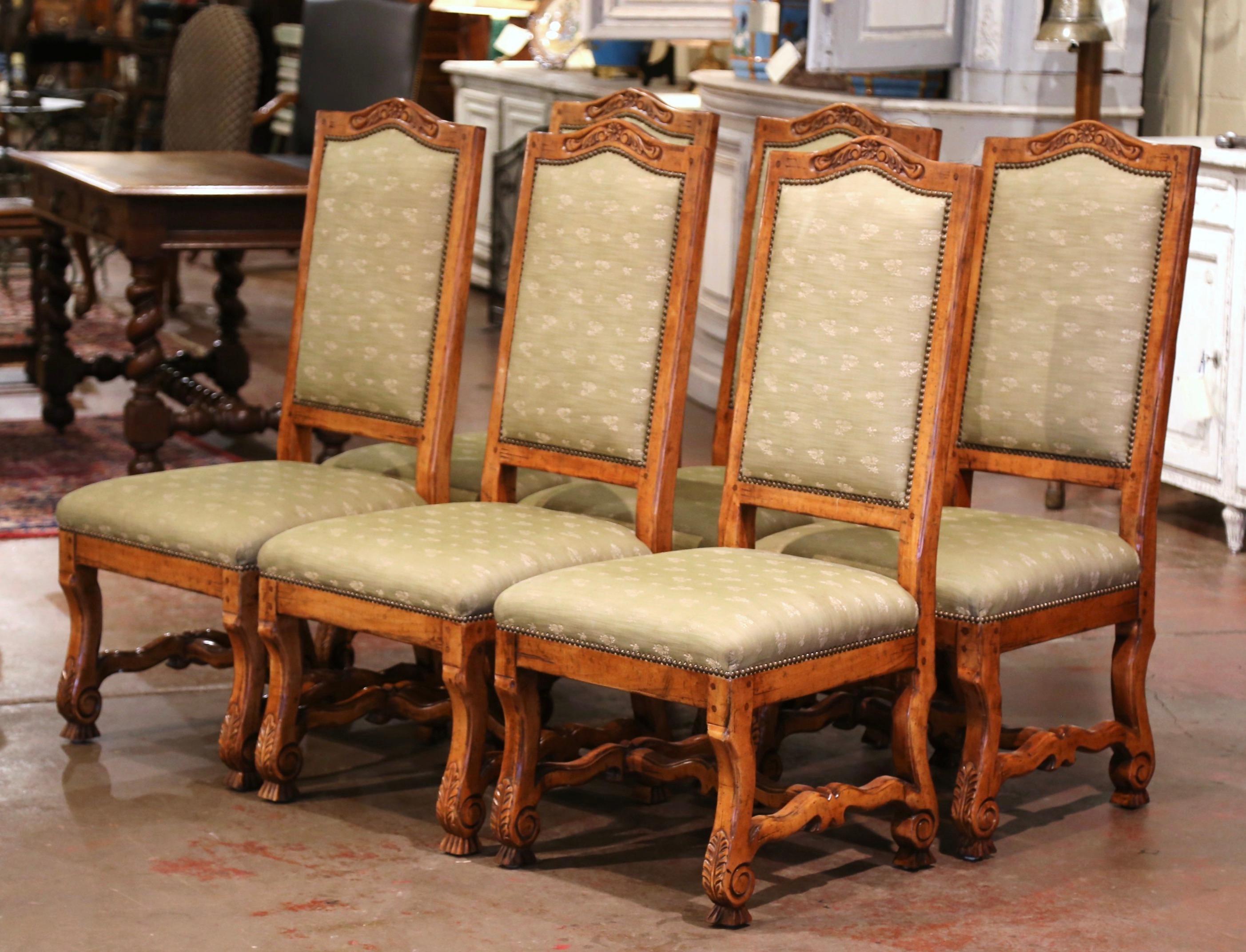 Place this elegant suite of six side chairs around your breakfast table for a true country French look. Crafted circa 1990 in the Louis XIII style, each chair stands on scrolled legs ending with bone feet over a scalloped bottom stretcher; the chair