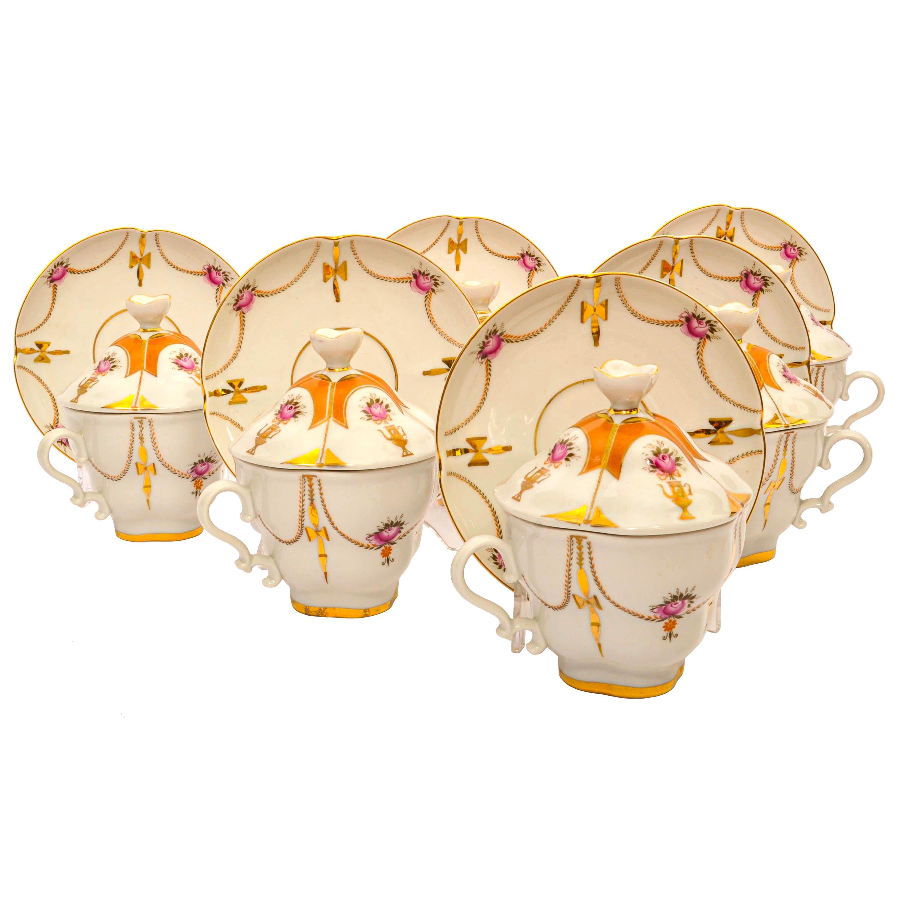 Vintage set of six Imperial Lomonosov Handpainted Gilt Porcelain tea cups & saucers with covers, comprising 18 pieces. 
The set is in perfect condition, each cup and saucer is hand decorated with swags and garlands and samovars, with yellow, orange