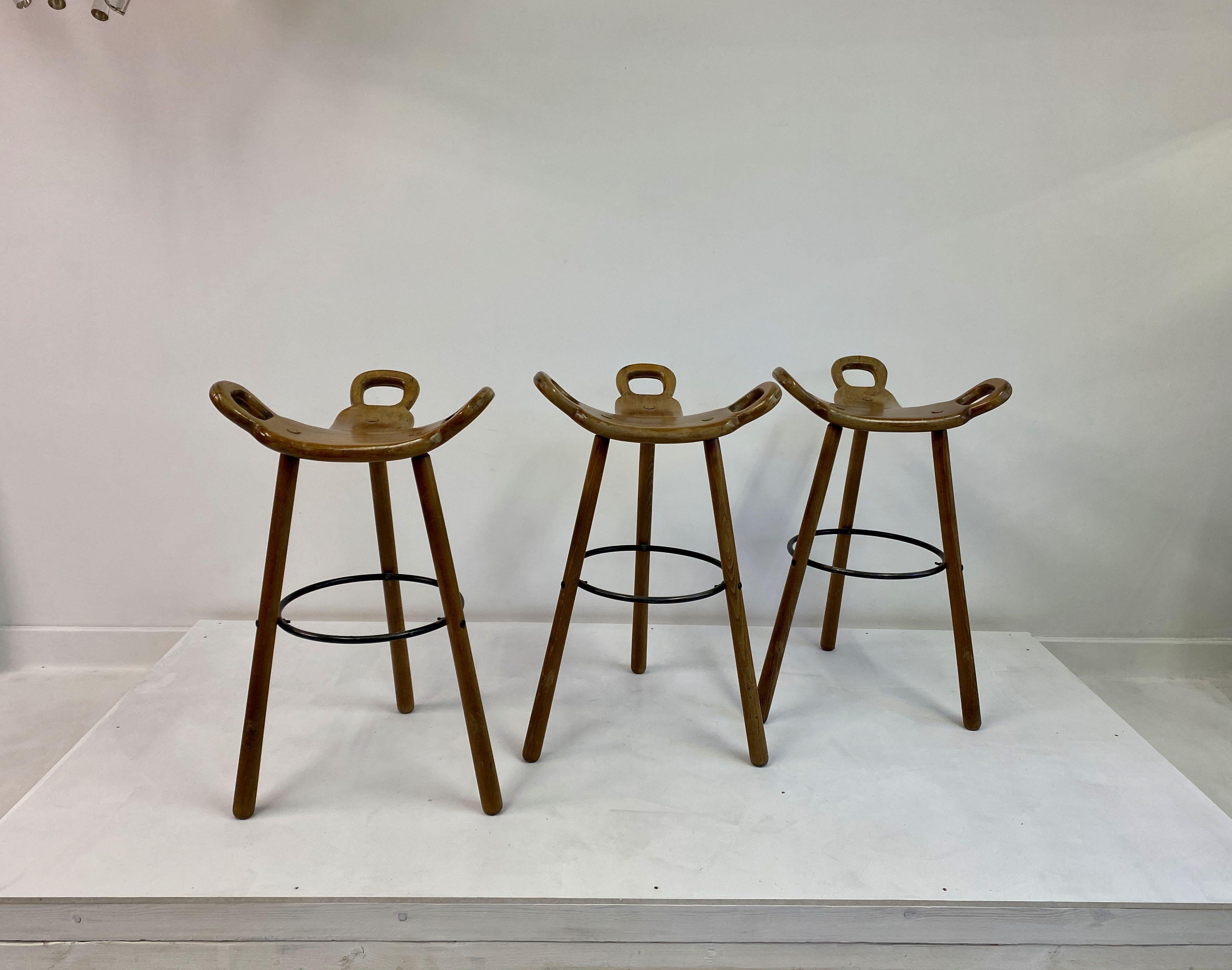 Set of three Brutalist or Marbella stools

Solid patinated beech

Three legged frame

Saddle shaped seat

Spain, 1970s.