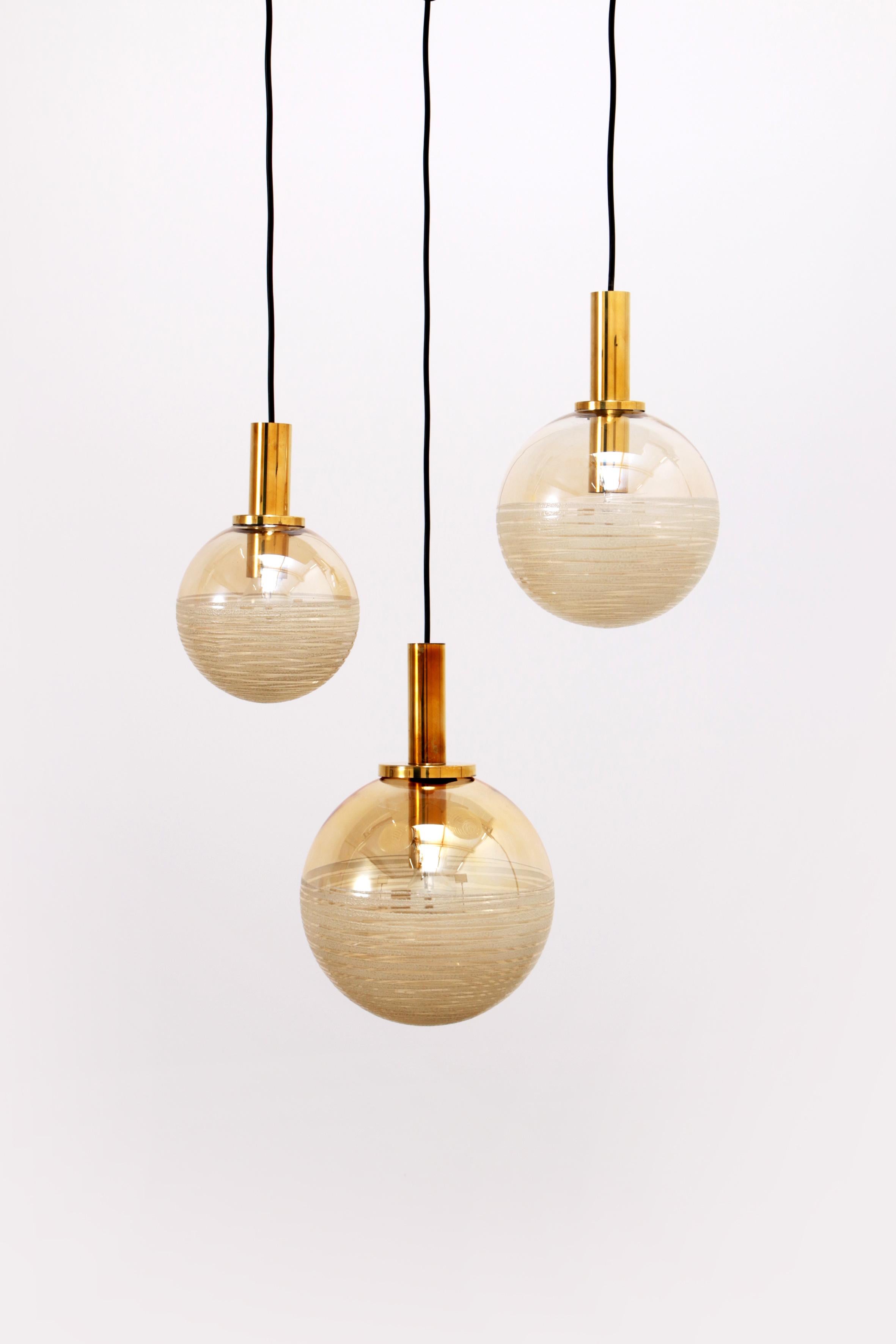 Vintage Set of three Glashutte Limburg hanging lamps, 1960s Germany.


These are three beautiful ball lamps with a beautiful amber color glass bulb. The bulbs have three different sizes and are beautiful as a set. Beautiful for your hall or above