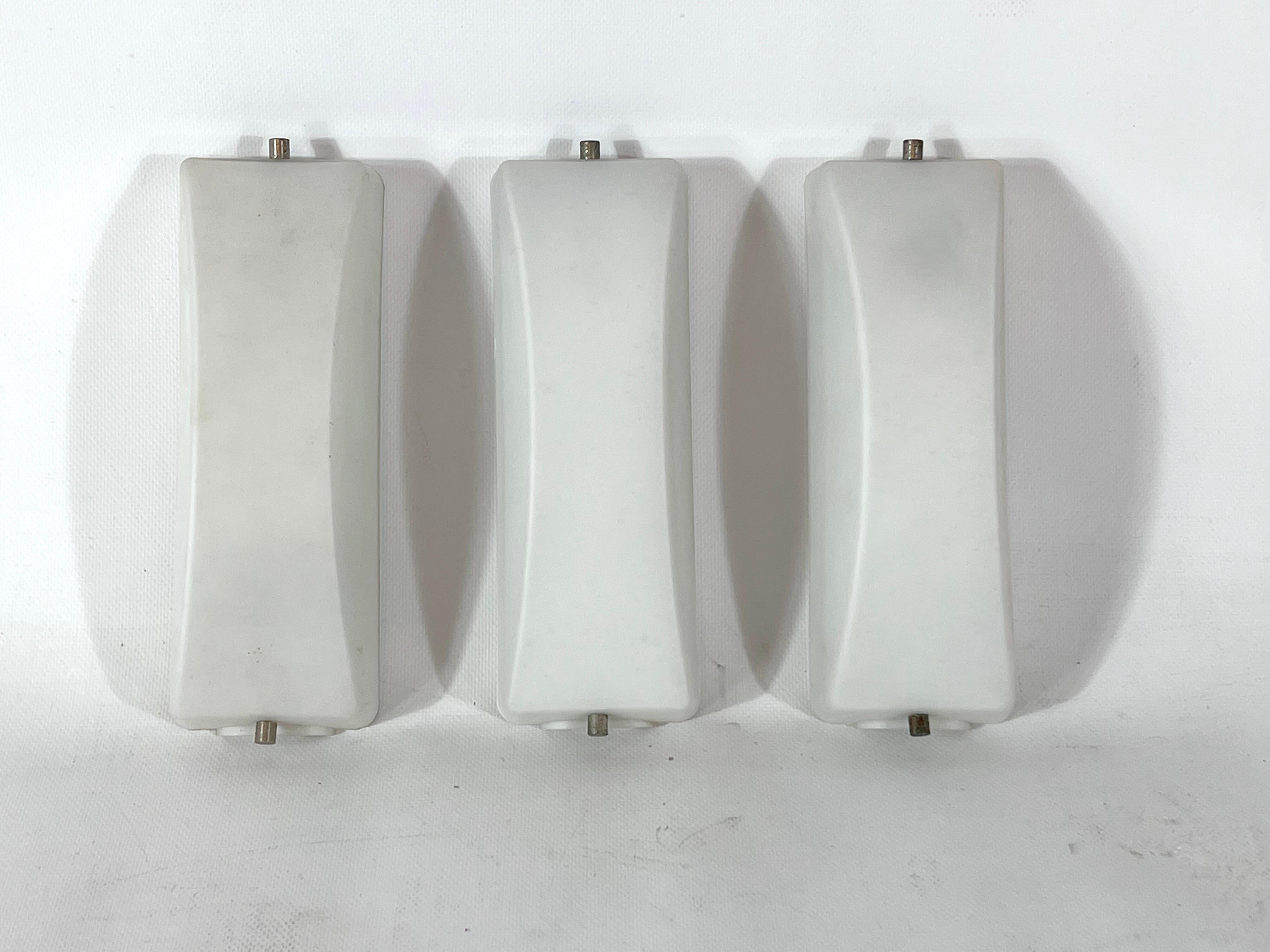 Good vintage condition with no chips or cracks for this set of three midcentury Italian sconces made from triplex opaline glass. Each sconce mounts a socket for E14 bulb. Full working with EU standard, adaptable on demand for USA standard.