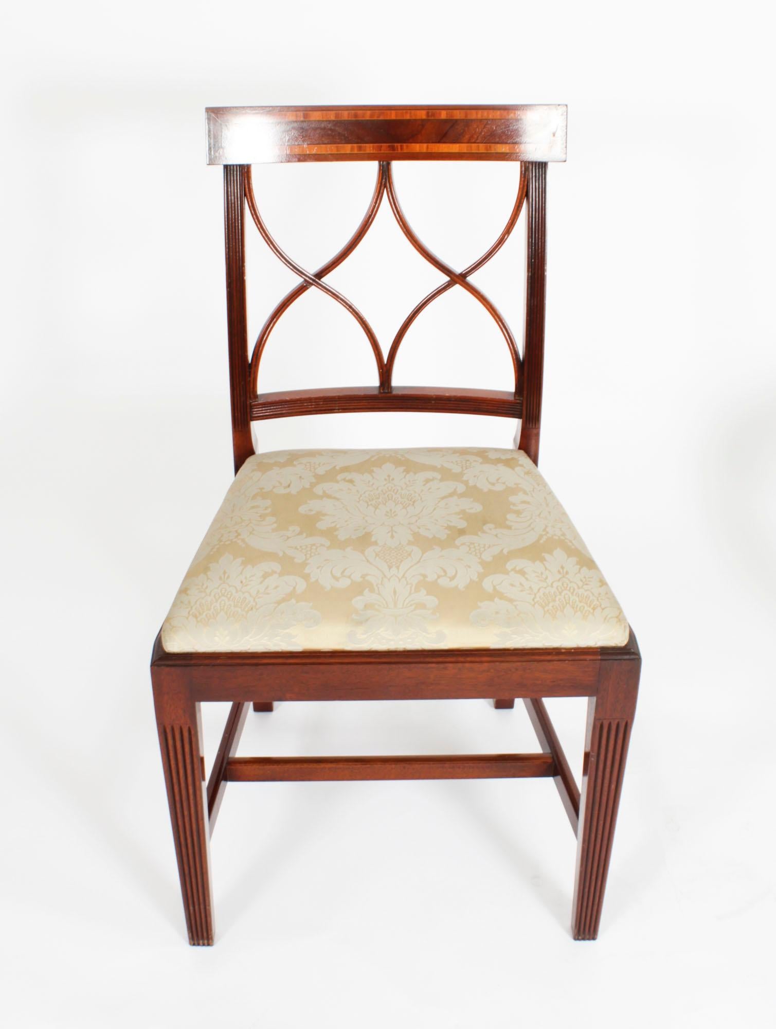This is a beautiful set of six Regency Revival flame mahogany dining chairs, dating from the second half of the 20th Century.

They are made of solid mahogany with fabulous satin wood crossbanded decoration accented with boxwood and ebony line