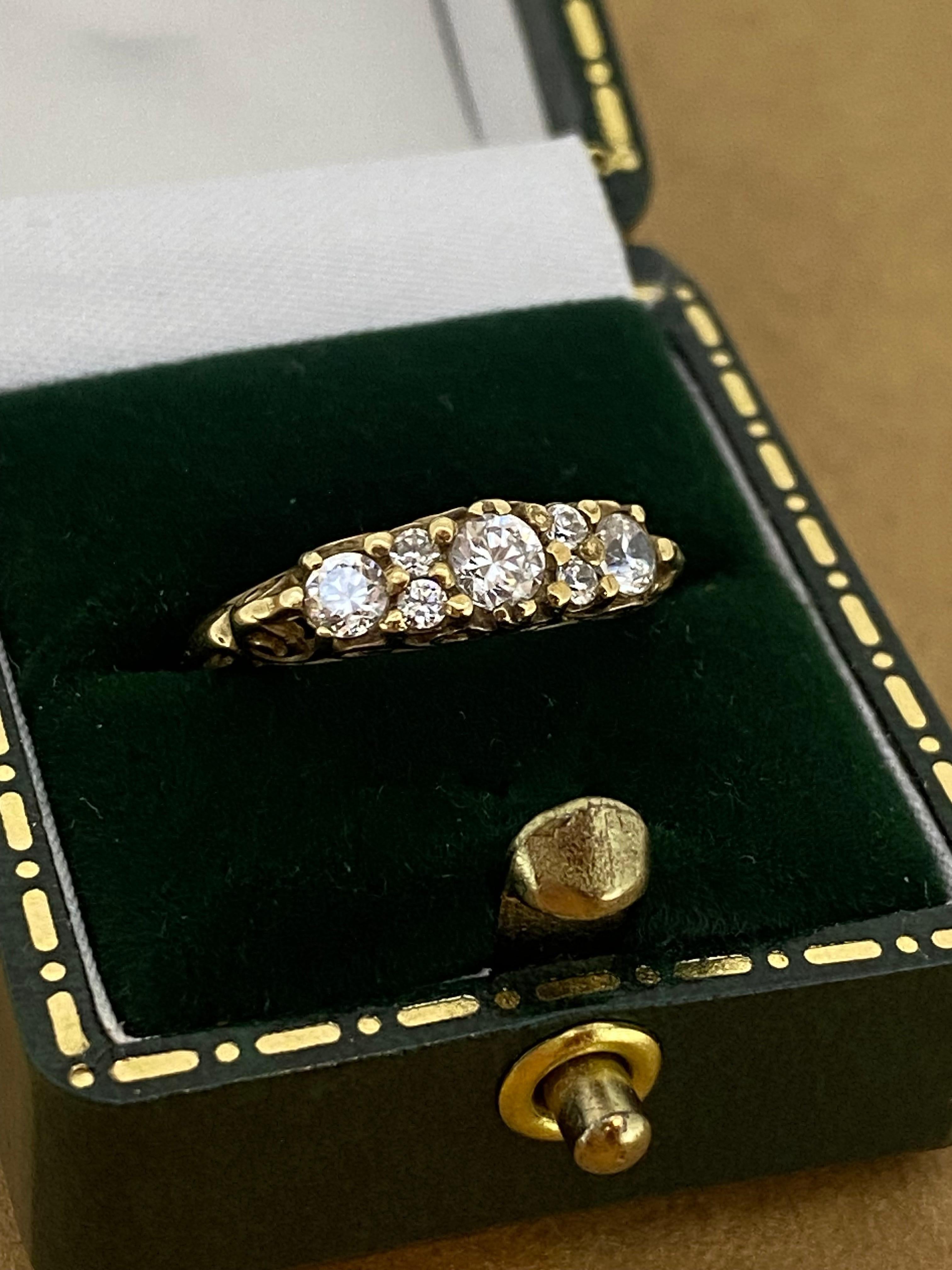 This exquisite piece of jewellery
is vintage, yet it's in beautiful condition & of unusual design 

Featuring 7 sparkling CZ’s (cubic zirconias)
securely set in intricate “filigree” half-hoop setting 
(rising 4.5mm above the finger)
within elegantly