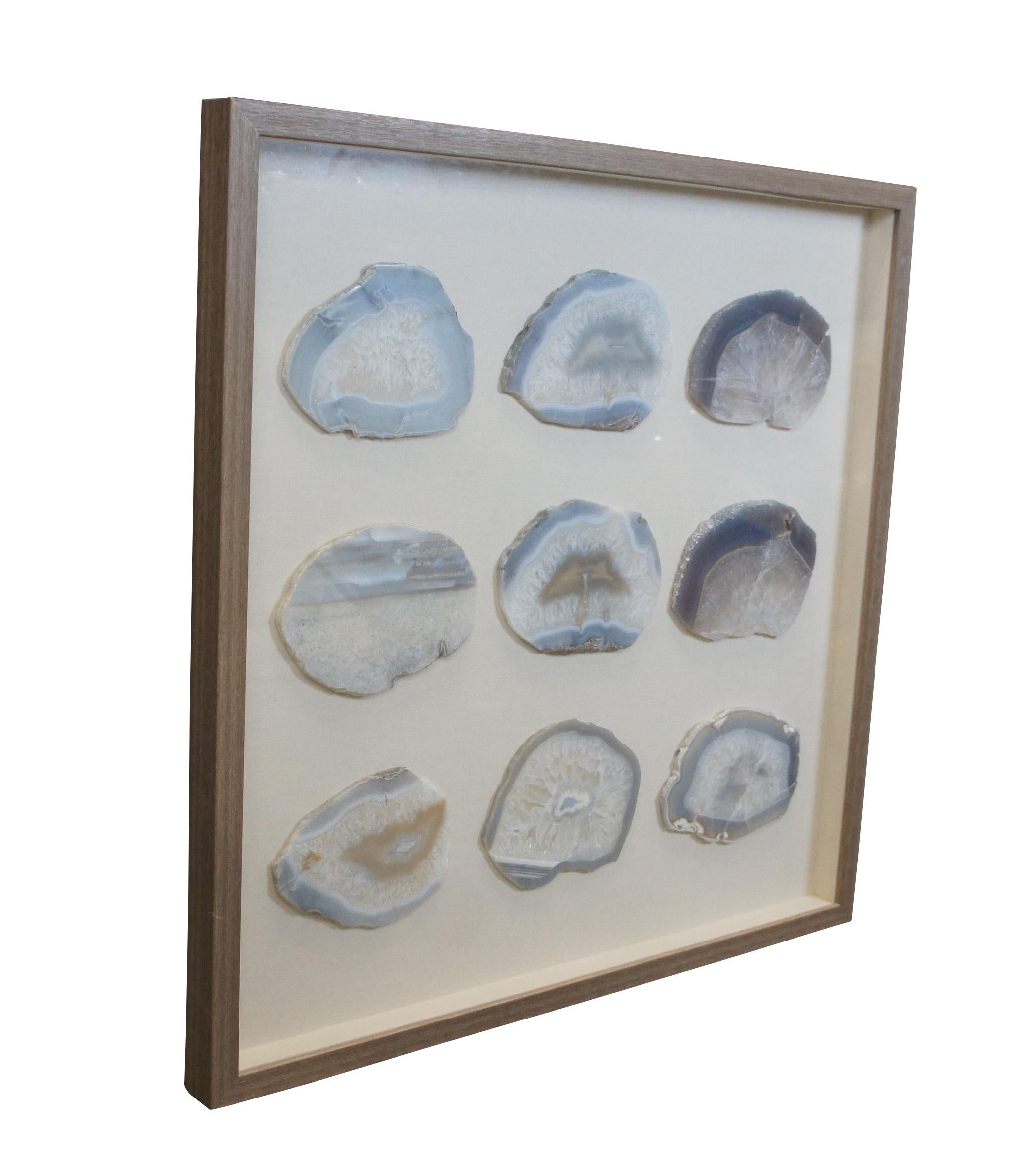 Late 20th century shadowbox framed array of nine blue, gray, and white striped agate / chalcedony / crystal fossil geode slices. Mounted on off-white linen. Weathered wood frame.

Dimensions:
31.5