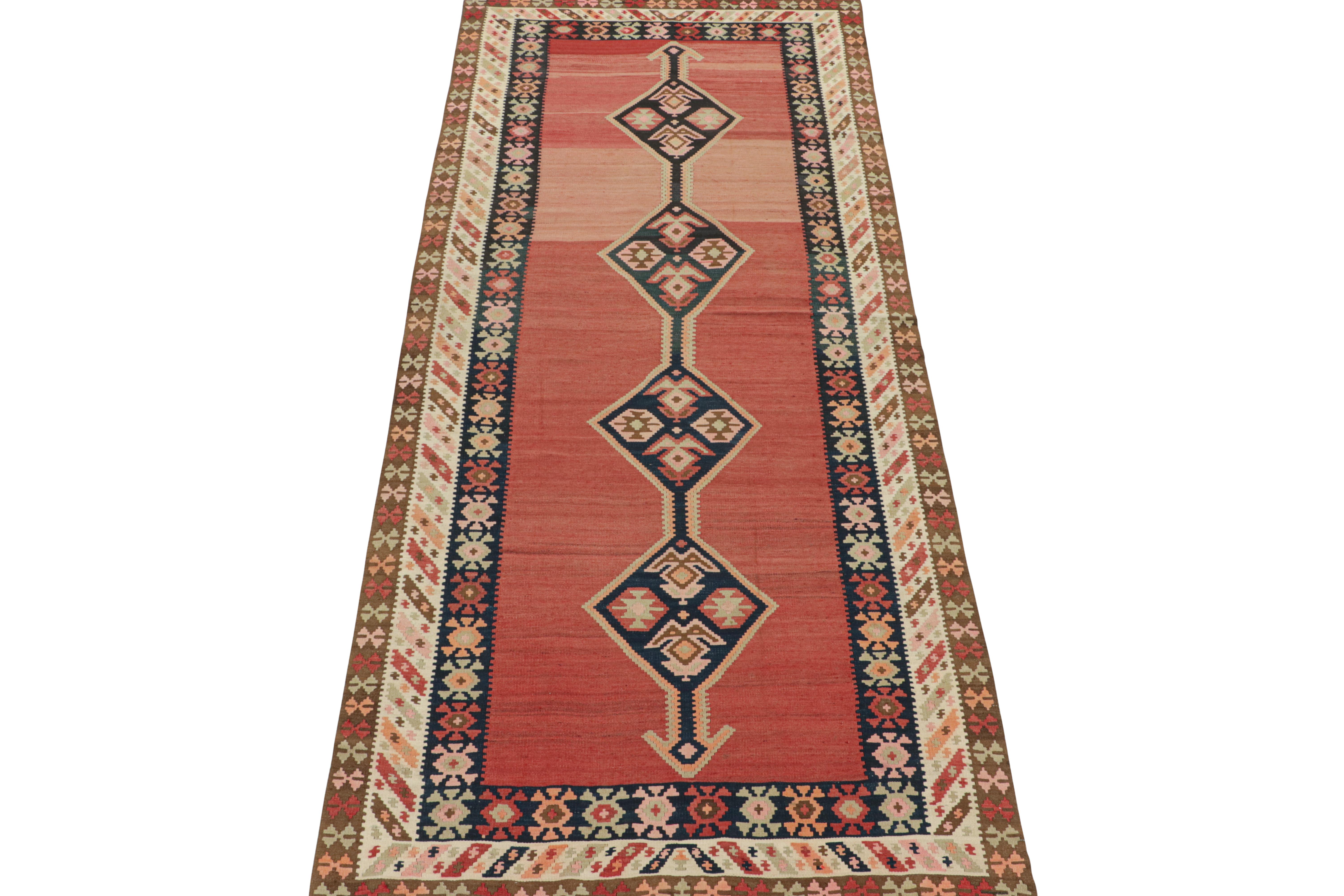 This vintage 5x13 Persian kilim is believed to be a Shahsavan tribal rug—handwoven in wool circa 1950-1960. 

Further on the Design:

The design prefers navy blue medallions on a red open field, wrapped in polychromatic borders with finely woven