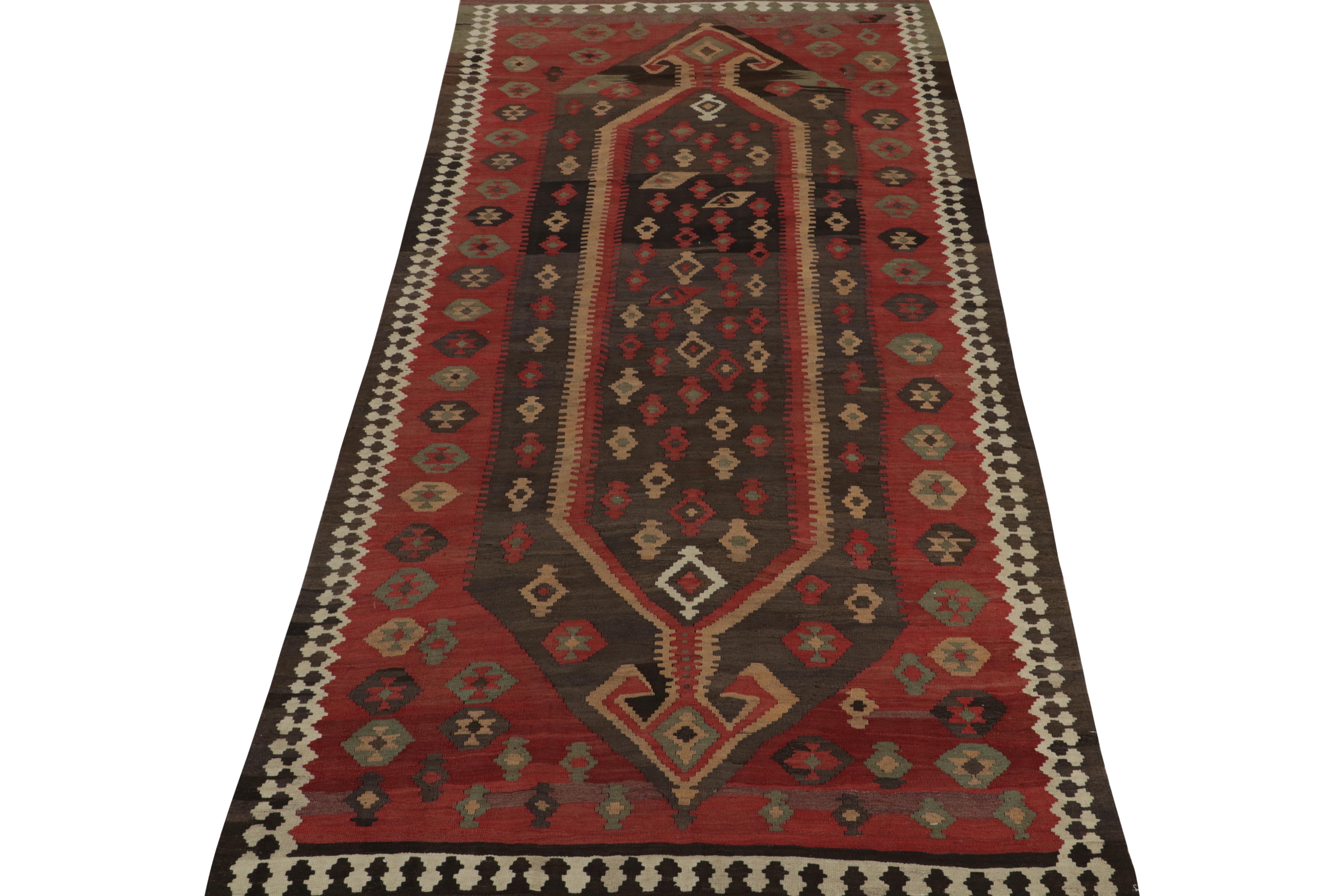 This vintage 5x11 Persian kilim is a Shahsavan rug of rare design—handwoven in wool circa 1950-1960.

Further on the Design:

This design favors rich brown and red in its medallion and geometric patterns, but also employs intriguing 
accents we