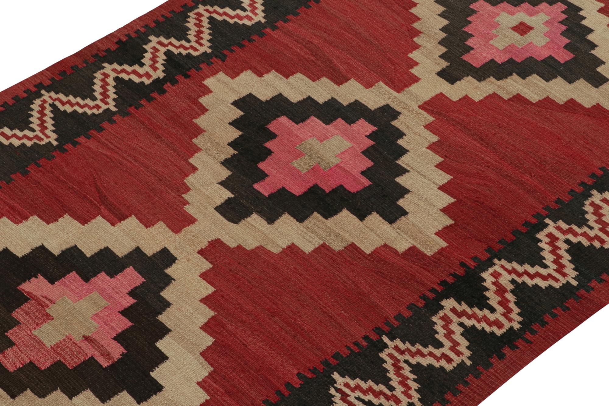 This vintage 5x7 Persian Kilim is believed to be a midcentury Shahsavan rug, handwoven in wool circa 1950-1960.

On the Design: 

This traditional tribal rug enjoys pink and beige-brown medallions on a rich red open field. Connoisseurs will note