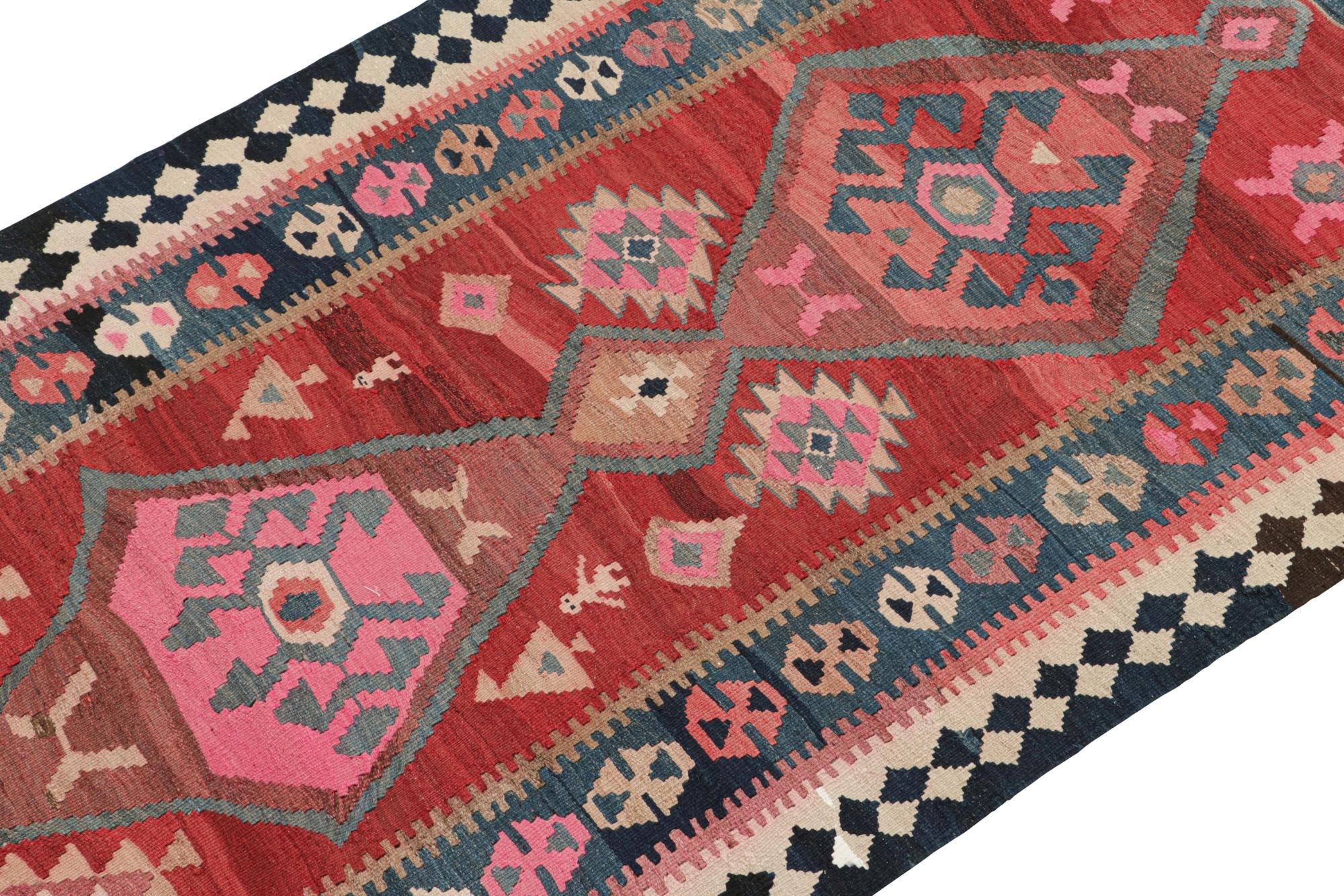 This vintage 4x9 Shahsavan Persian kilim is handwoven in wool, and originates circa 1950-1960.

On the Design:

This rare piece enjoys medallions on the open field favouring red, beige-brown & blue with hints of vibrant pink - beautifully