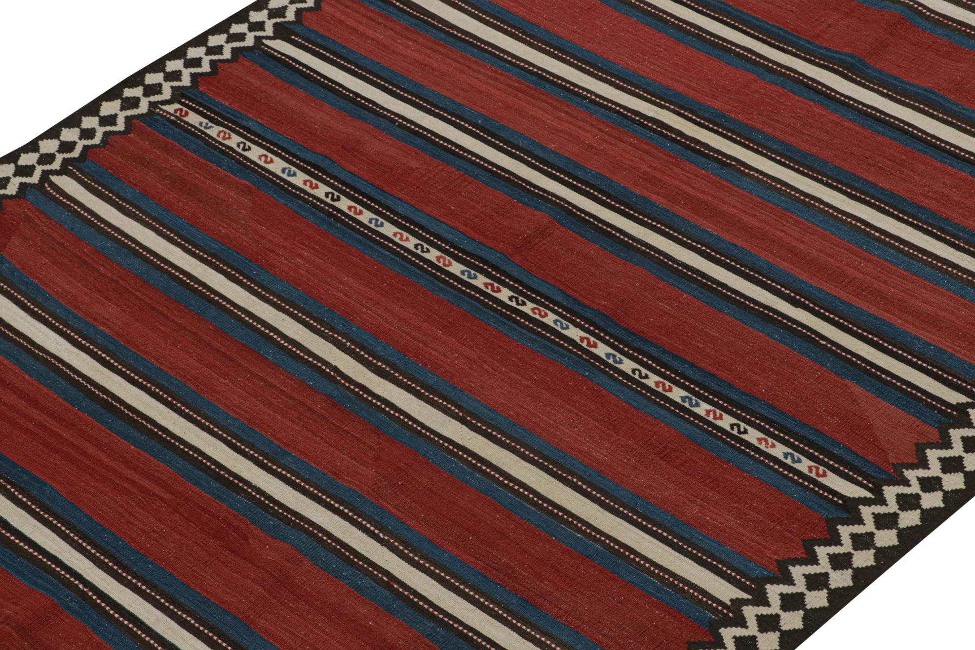 This vintage 5x11 Shahsavan Persian Kilim is handwoven in wool, and originates circa 1950-1960.

On the Design: 

The piece enjoys striped patterns in red & blue encased in black & white tribal borders. A keen eye would note fine tribal patterns