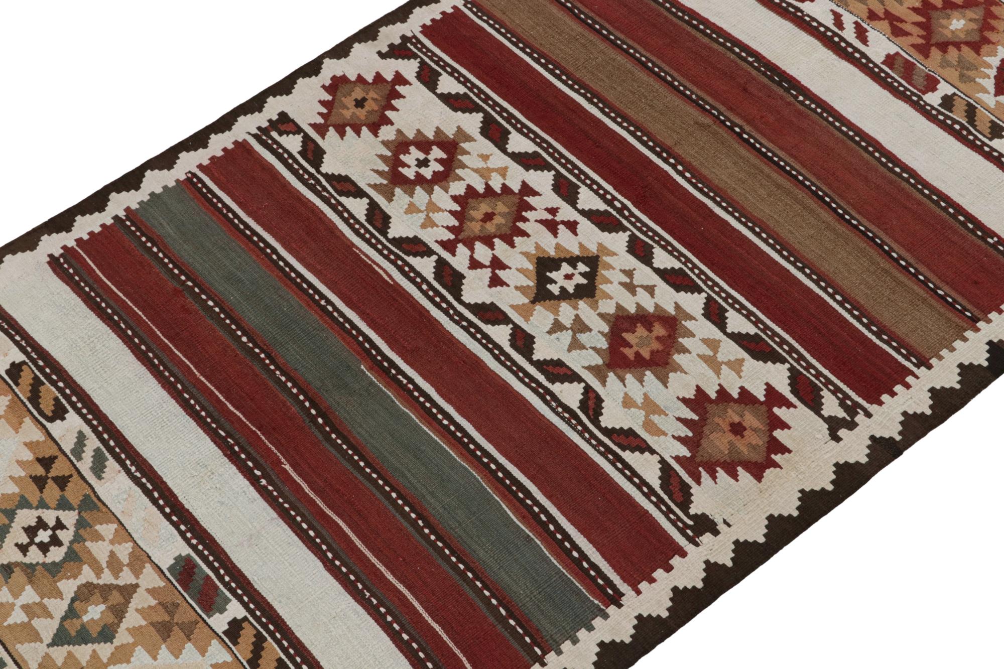 This vintage 5x12 Persian Kilim is believed to be a Shahsavan tribal rug—handwoven in wool circa 1950-1960.

On the Design: 

This runner enjoys stripes and geometric patterns in rust, burgundy red, beige-brown, teal and white tones in its wide