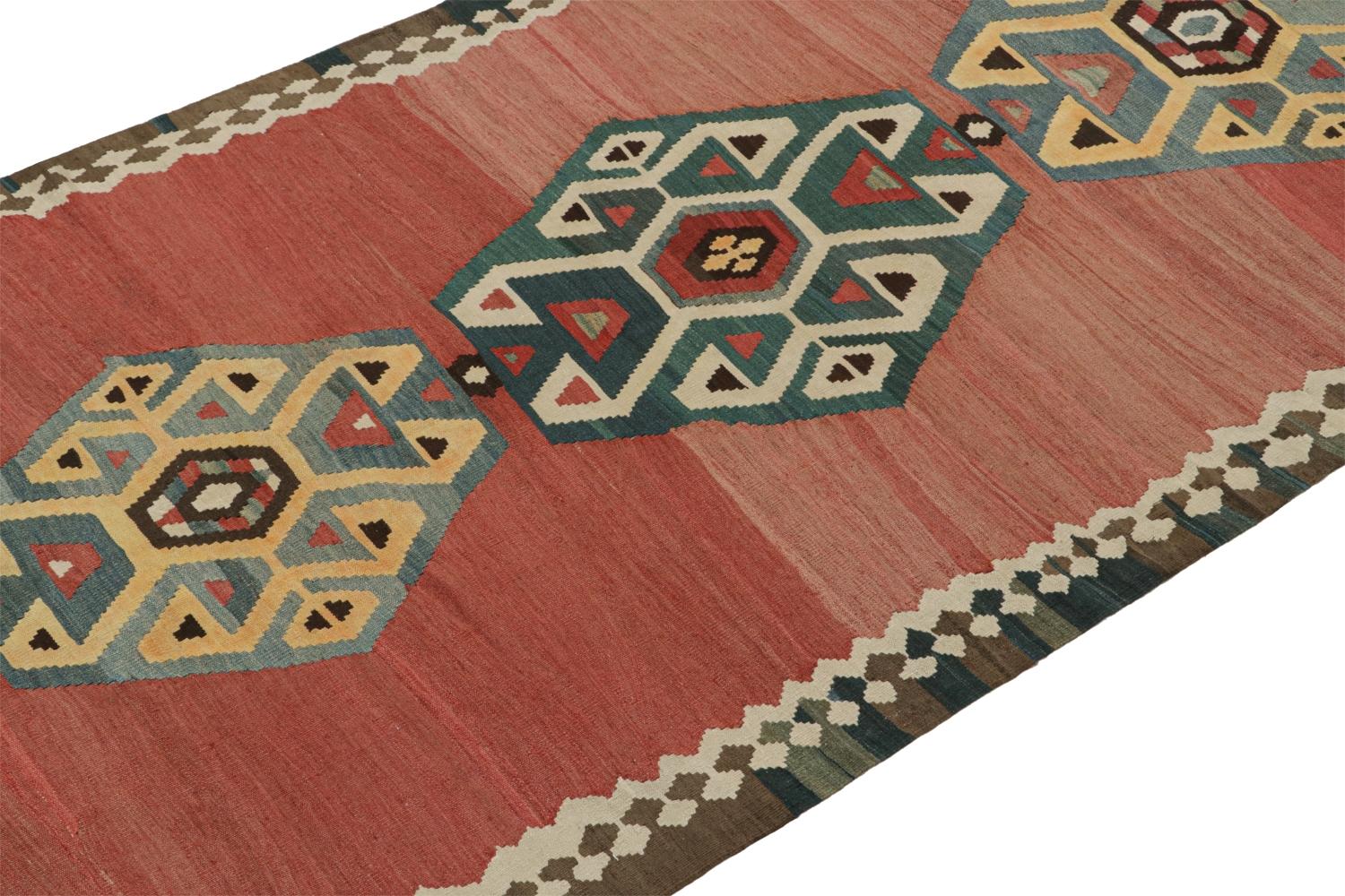 This vintage 5x12 Persian Kilim is a midcentury tribal rug that we believe originates from the Shahsavan tribe. 

On the Design:

Handwoven in wool circa 1950-1960, its design enjoys polychromatic medallions patterns on a red open field.