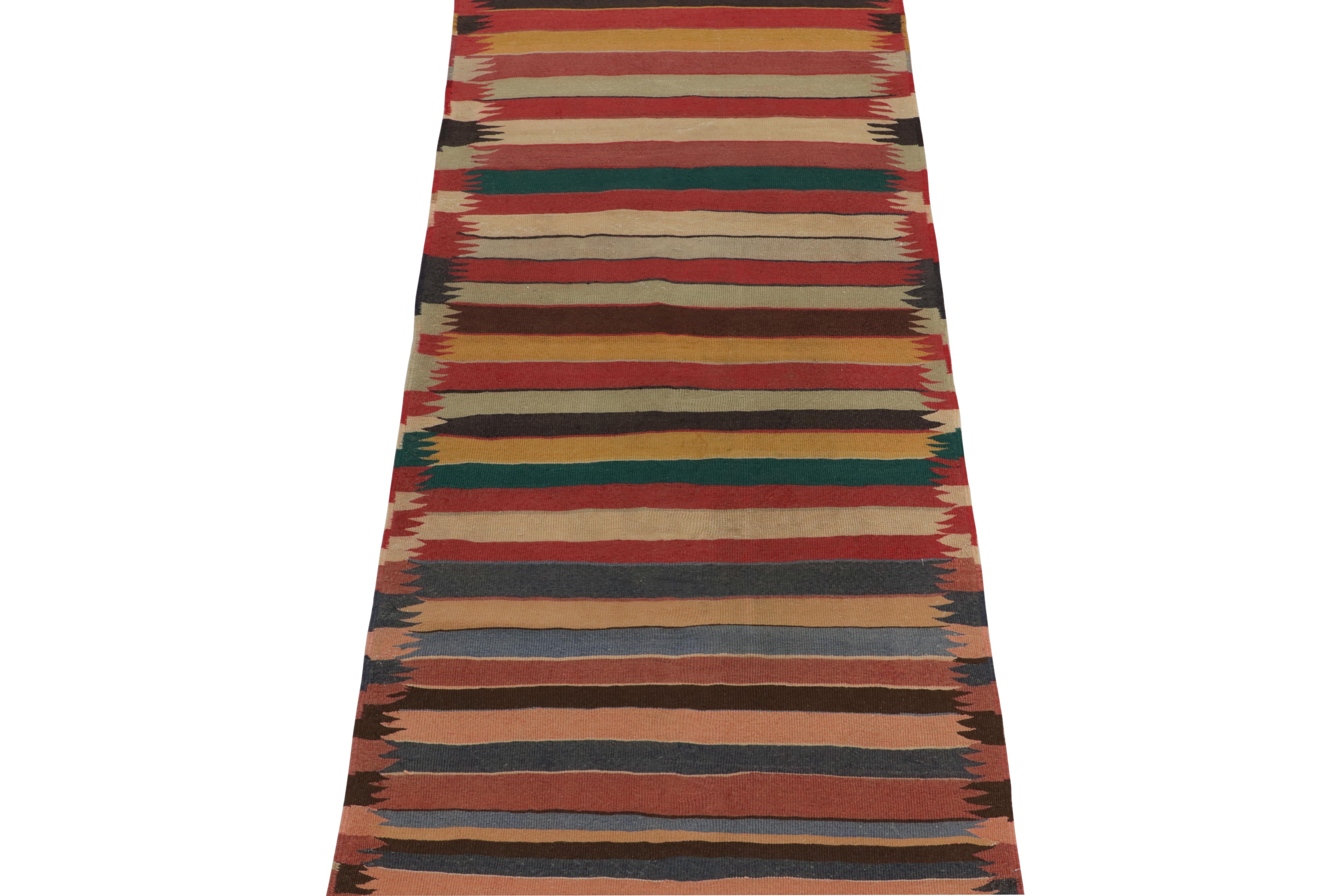 This vintage 4x11 Shahsavan kilim is a unique tribal rug for its period and provenance. Handwoven in wool, it originates from Turkey circa 1950-1960. 

Further on the Design:

The field hosts horizontal stripes alternating in red, beige-brown, blue,