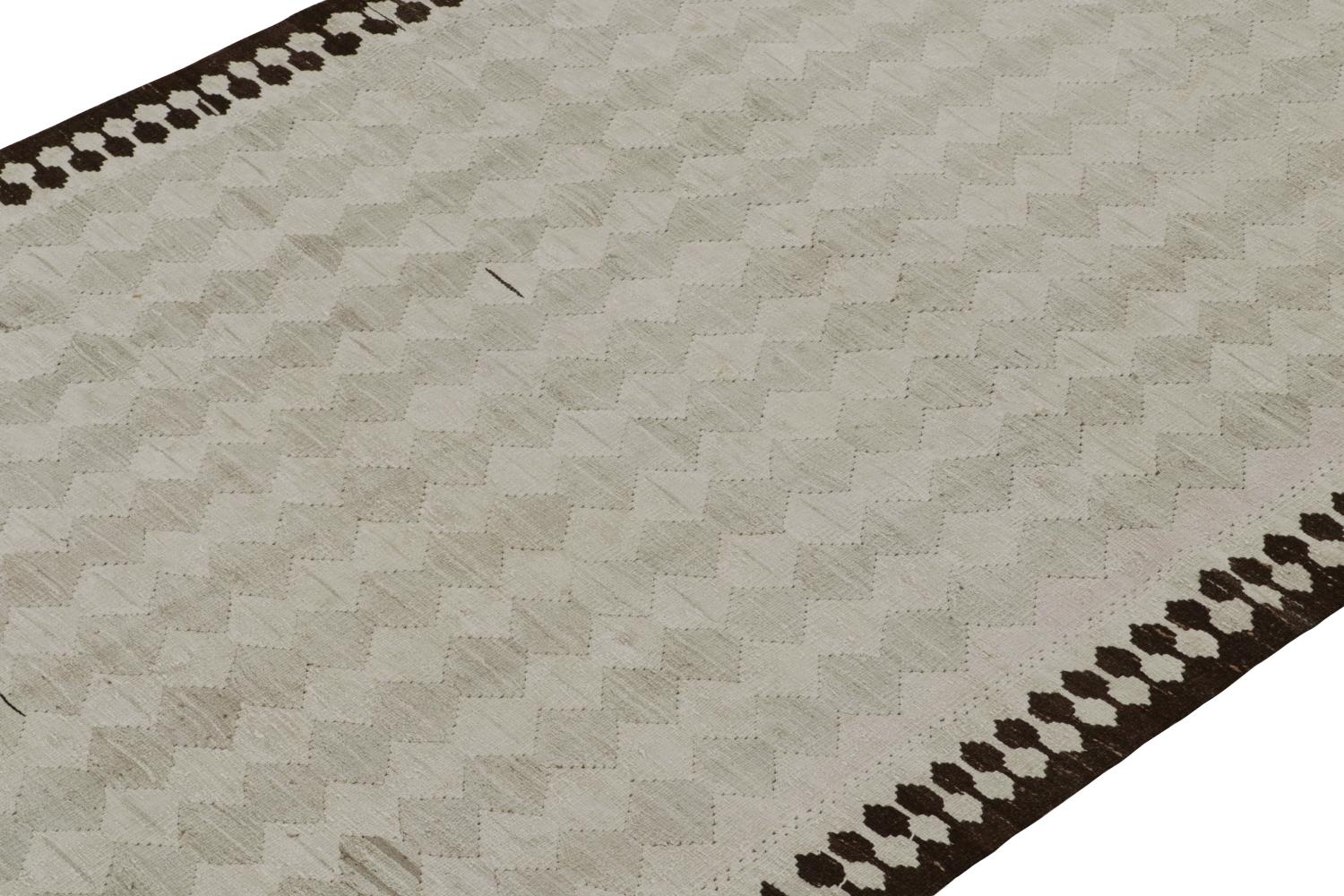 This vintage 5x10 Persian Kilim is a midcentury tribal rug believed to hail from the Shahsavan tribe—handwoven in wool circa 1950-1960.

On the Design: 

The field hosts sharp rows of light gray geometric patterns within a rich brown fencepost