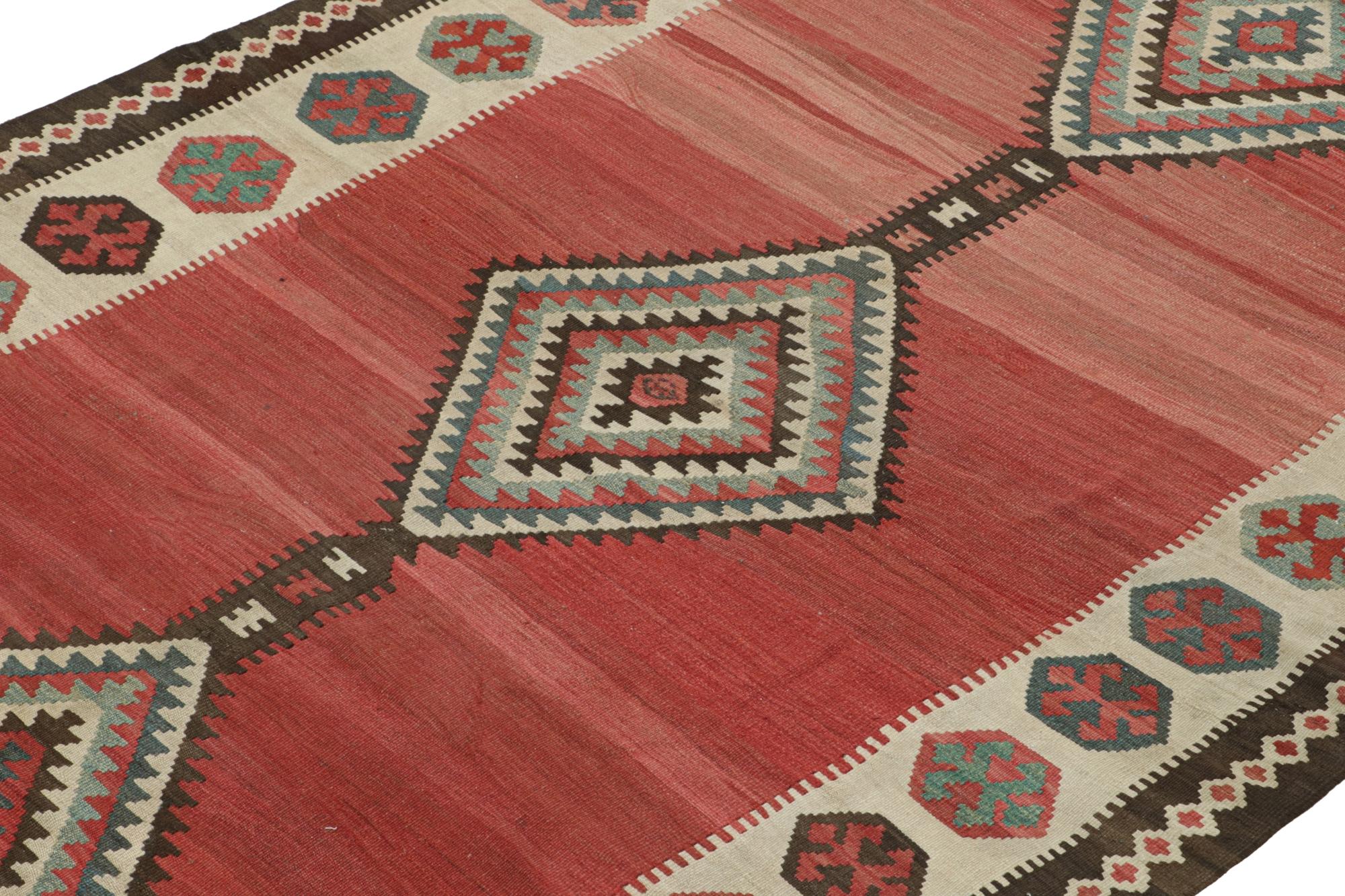 Handwoven in wool circa 1950, this 5x11 vintage Shahsavan Persian kilim is an exciting new curation.

On The Design:

This flatweave enjoys sharp medallions on a bold red open field, with the same hue beside beige-brown and sky blue.