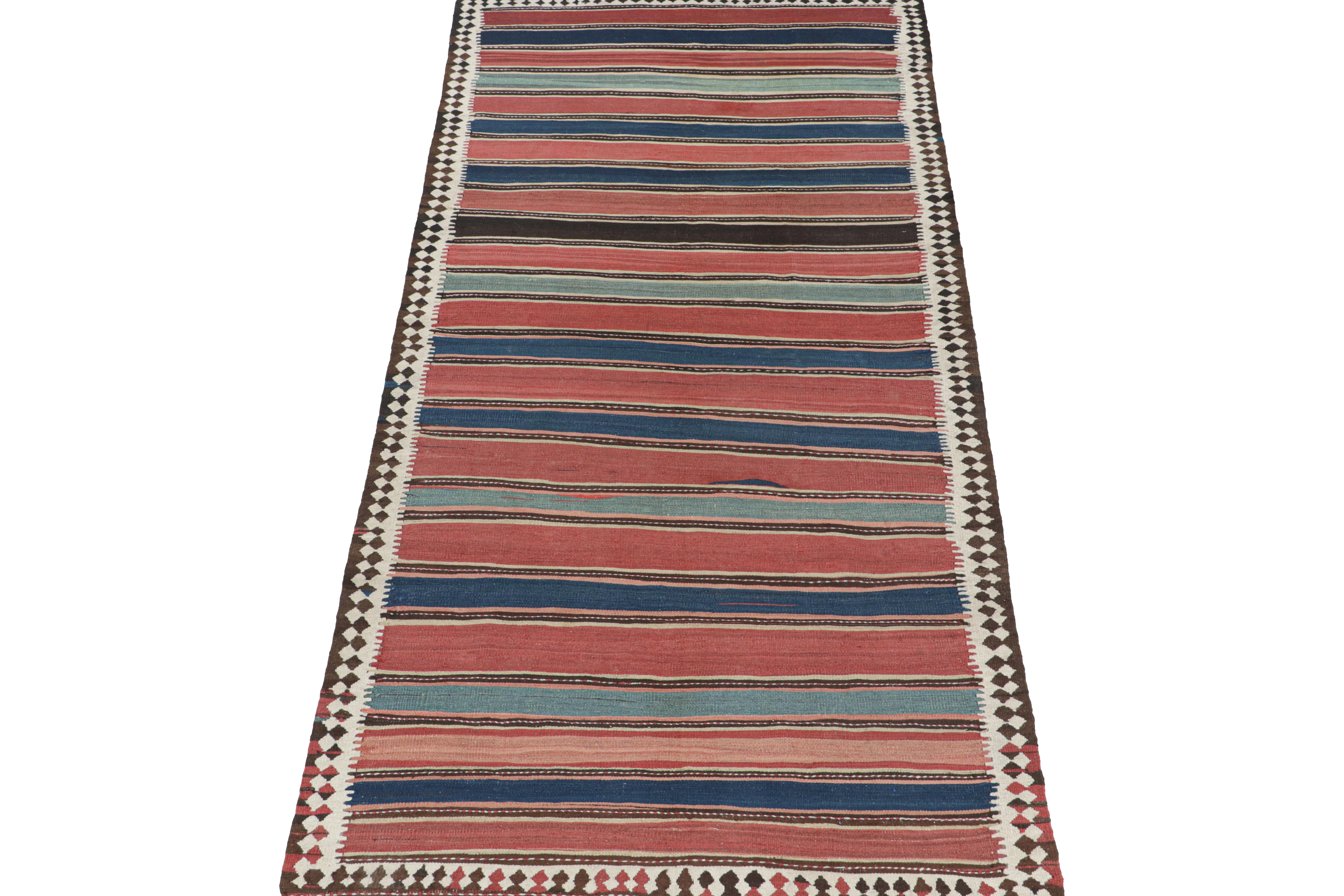 This vintage 5x11 Persian Kilim is believed to be a Shahsavan tribal rug. Handwoven in wool, it originates circa 1950-1960 and enjoys a play of stripes and geometric patterns in red, blue, and brown.

Further on the Design:

Keen eyes may further