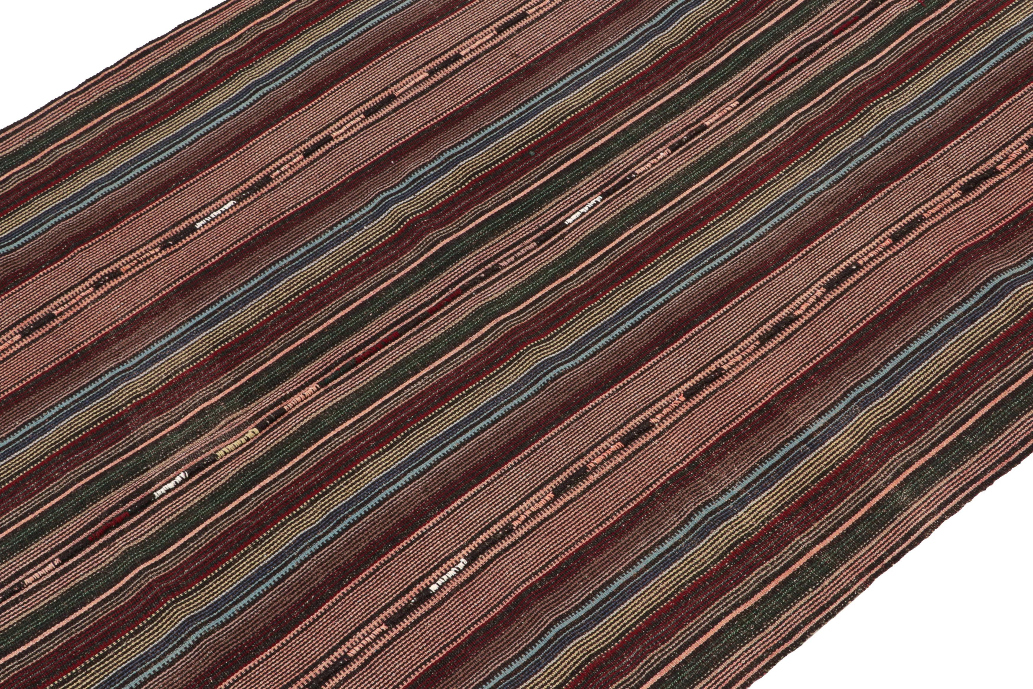 This vintage 6x12 Persian kilim is handwoven in wool, and originates circa 1950-1960.

On the Design: 

Specifically a Shahsavan “Palas”, this flatweave enjoys polychromatic stripes in red, blue & green with especially present pink notes. This is a