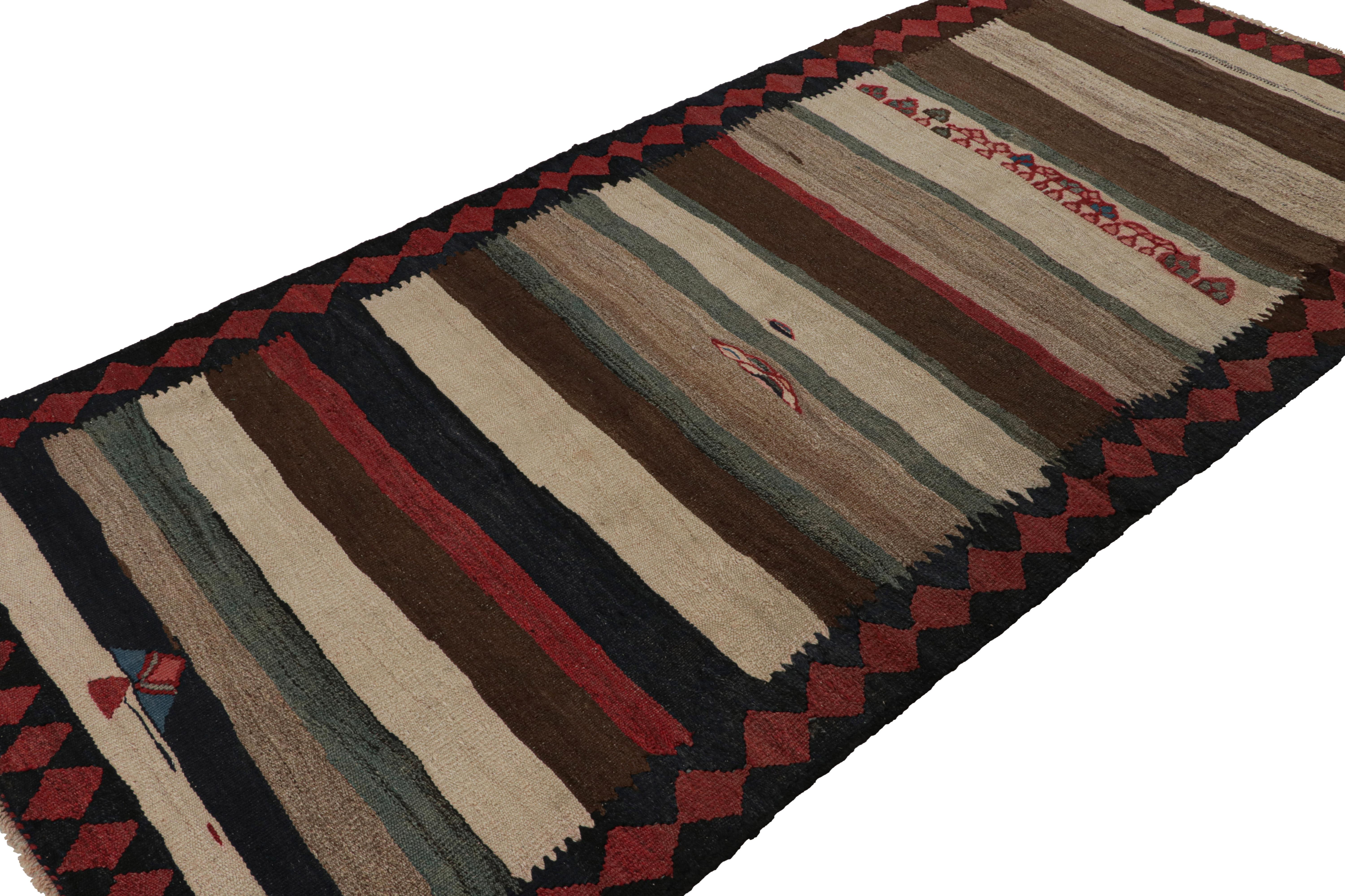 Handwoven in wool, circa 1950-1960, this 6x10 vintage Shahsavan Persian tribal kilim rug is a rich primitivist piece with stripes and motifs together. 

On the Design: 

Representing Shahsavan tribal design aesthetics, this rug features a