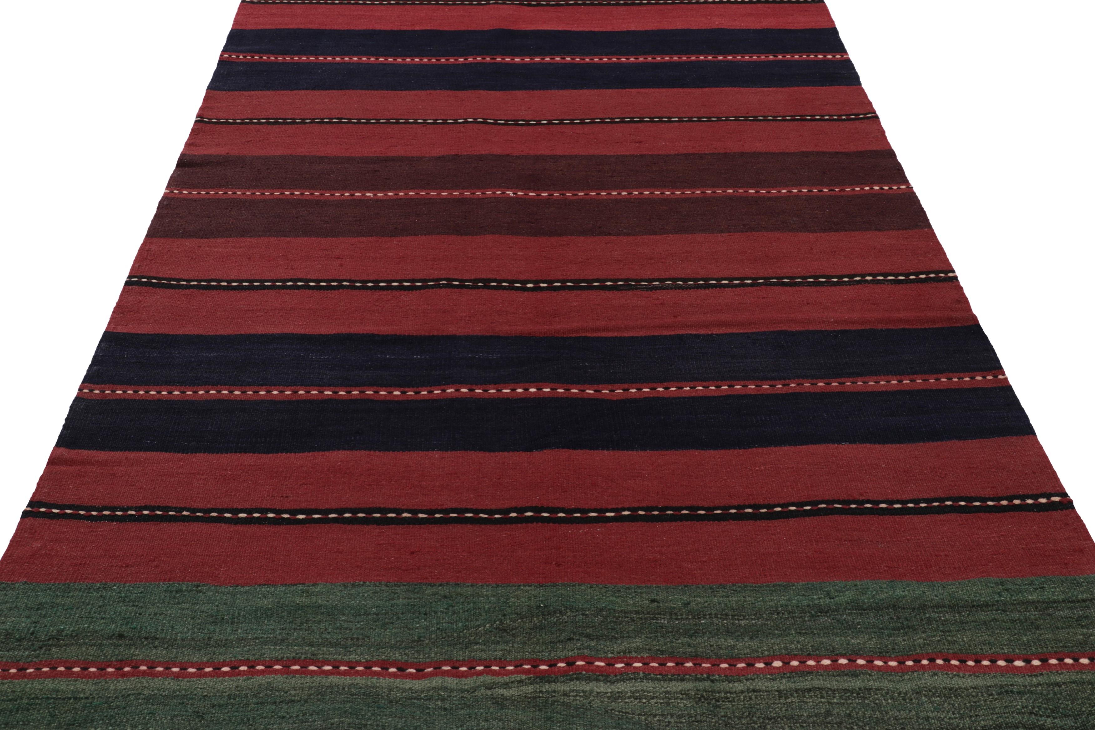 This vintage 6x11 Persian kilim is a mid-century Bakhtiari tribal rug, handwoven in wool circa 1950-1960.

On the Design: 

The mid-century Persian kilim features a vibrant striped design dominated by alternating fields of deep red, green and black