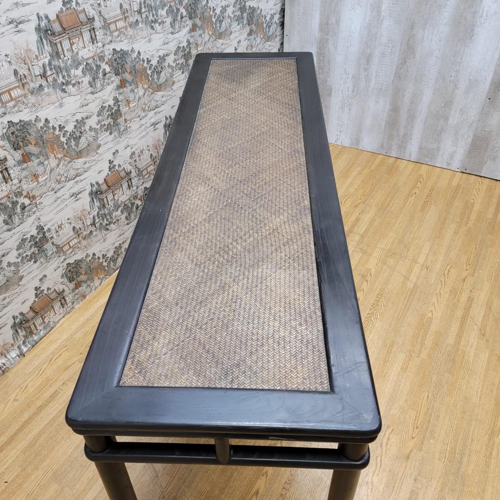 Vintage shanxi province black lacquer wicker rattan altar table.

This vintage altar table features a single board flush floating panel with circular legs. This table will elevate any room or entryway. 

Circa: 1999. 

Dimensions:

W: 69