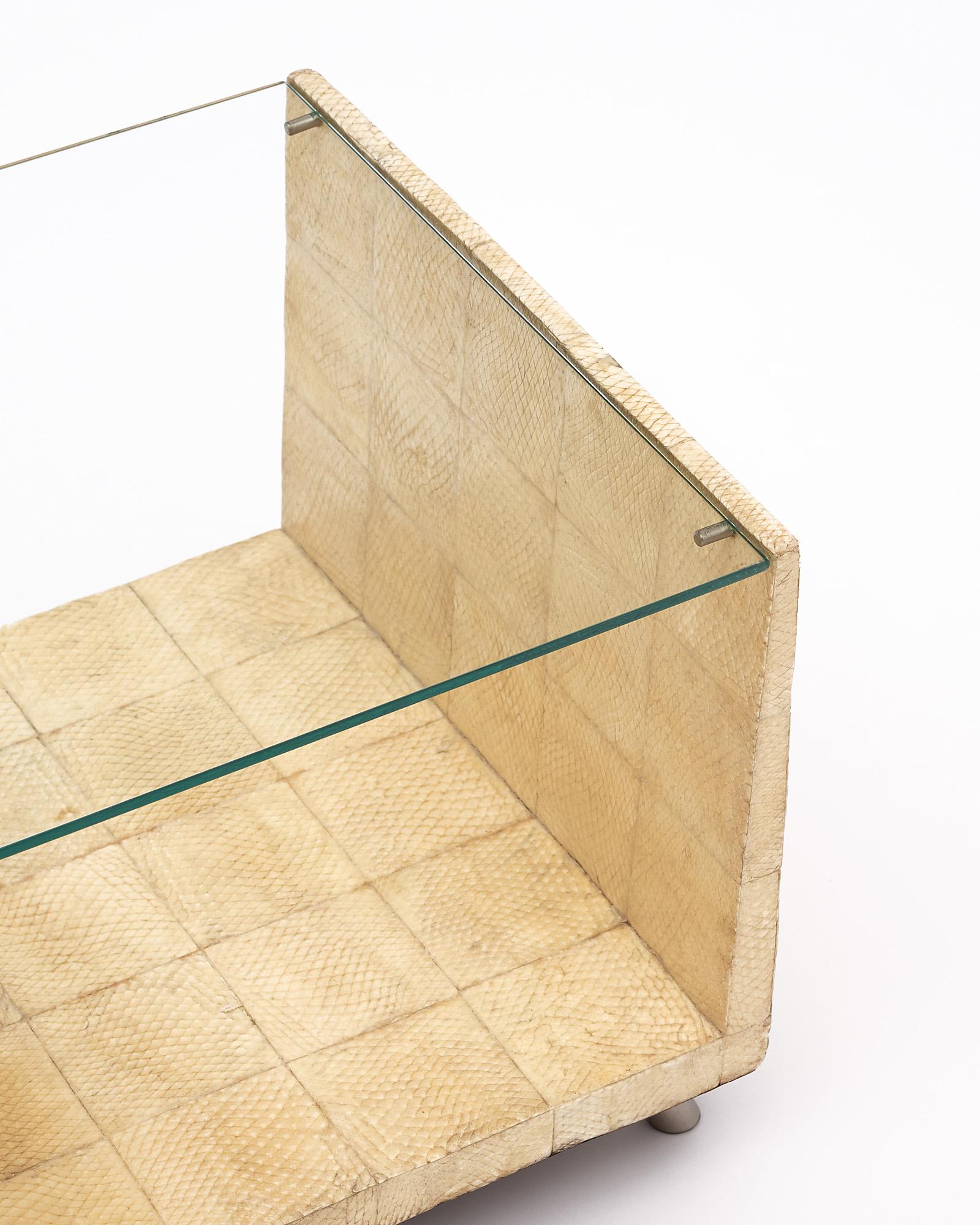 A table by Yuri Augusti designed and executed in Paris, circa 1990. This piece has a wood frame with sharkskin vellum. There is a glass shelf on top.