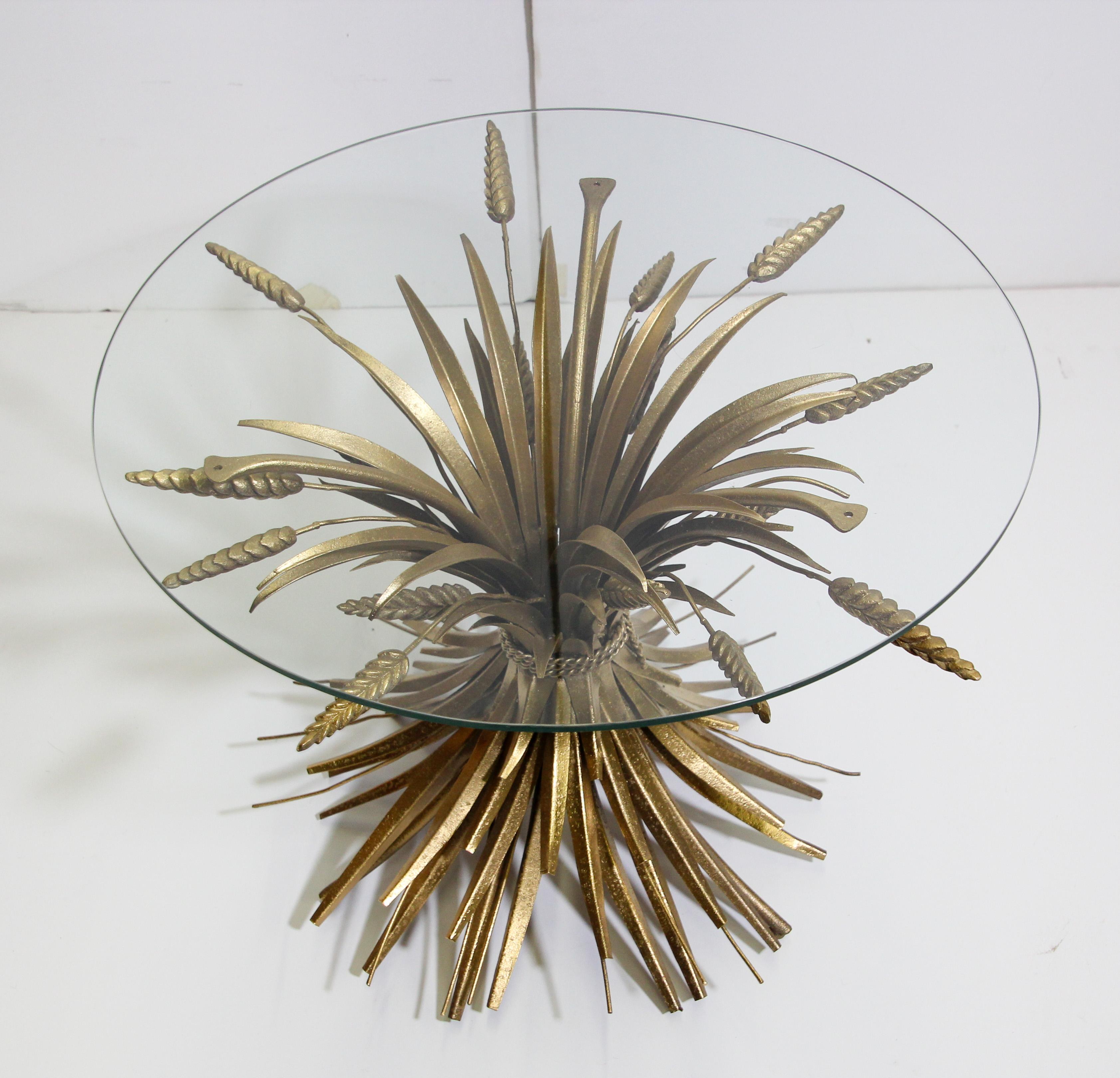 Vintage French midcentury gilded metal side table.
As seen in French Designer Coco Chanel Parisian apartment.
Classic and stylish side table with wheat sheaf base, made of gilded metal and a round glass top.
Nicely handcrafted with rope and wheat