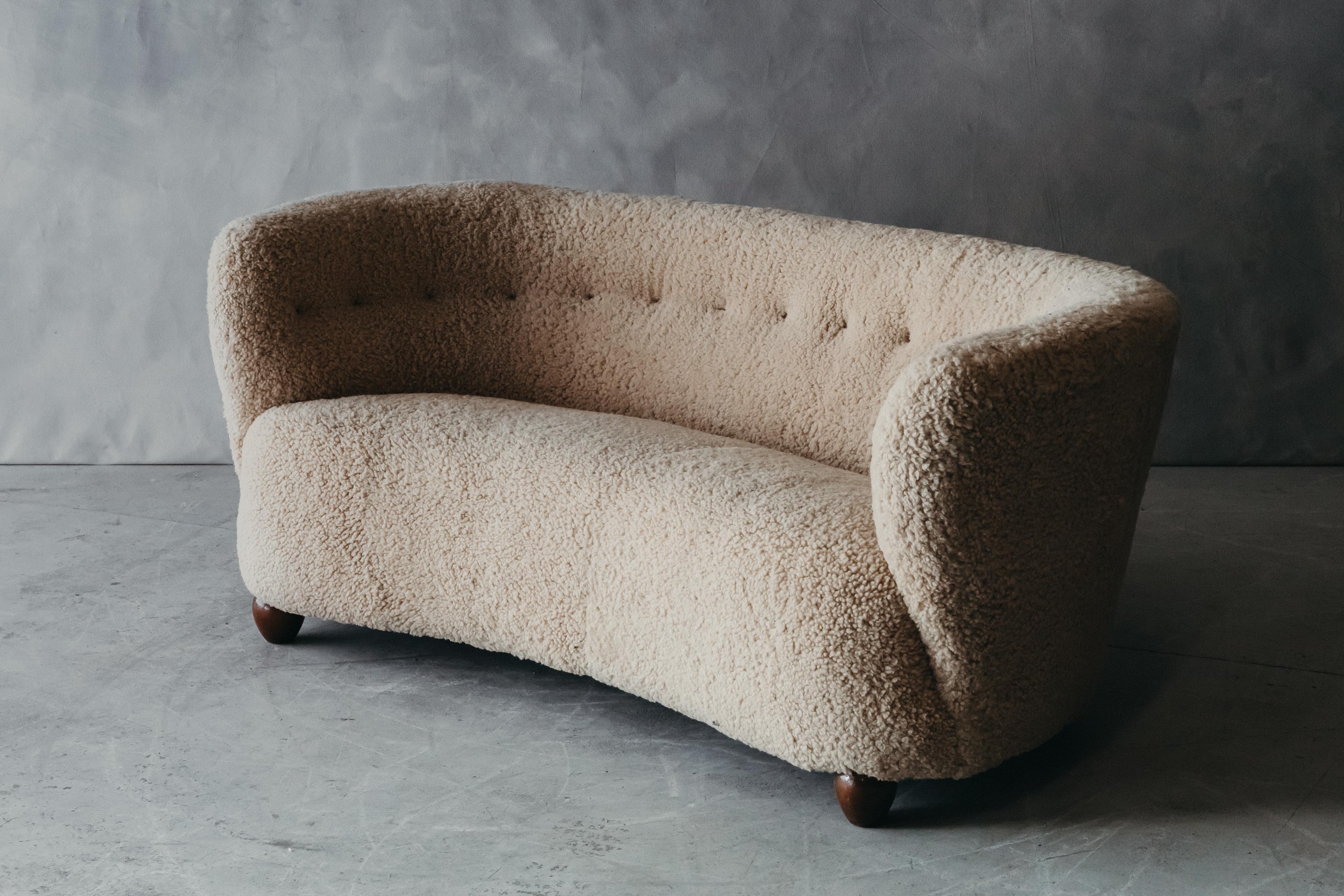 Vintage shearling cabinetmaker sofa from Denmark, circa 1950. Late upholstered in Denmark with premium shearling. Excellent condition.

We don't have the time to write an extensive description on each of our pieces. We prefer to speak directly with