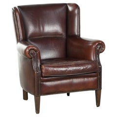 Vintage sheepskin armchair with a high back finished with decorative nails