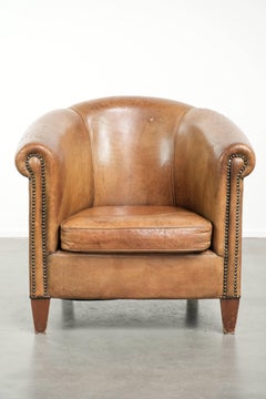 Vintage sheepskin club armchair finished with decorative nails