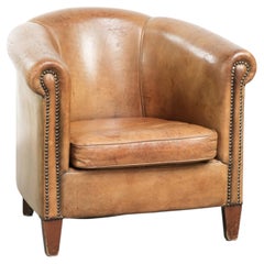 Vintage sheepskin club armchair finished with decorative nails