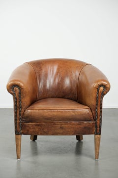 Vintage sheepskin club armchair in a subtle size with warm colours