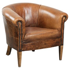 Vintage sheepskin club armchair in a subtle size with warm colours