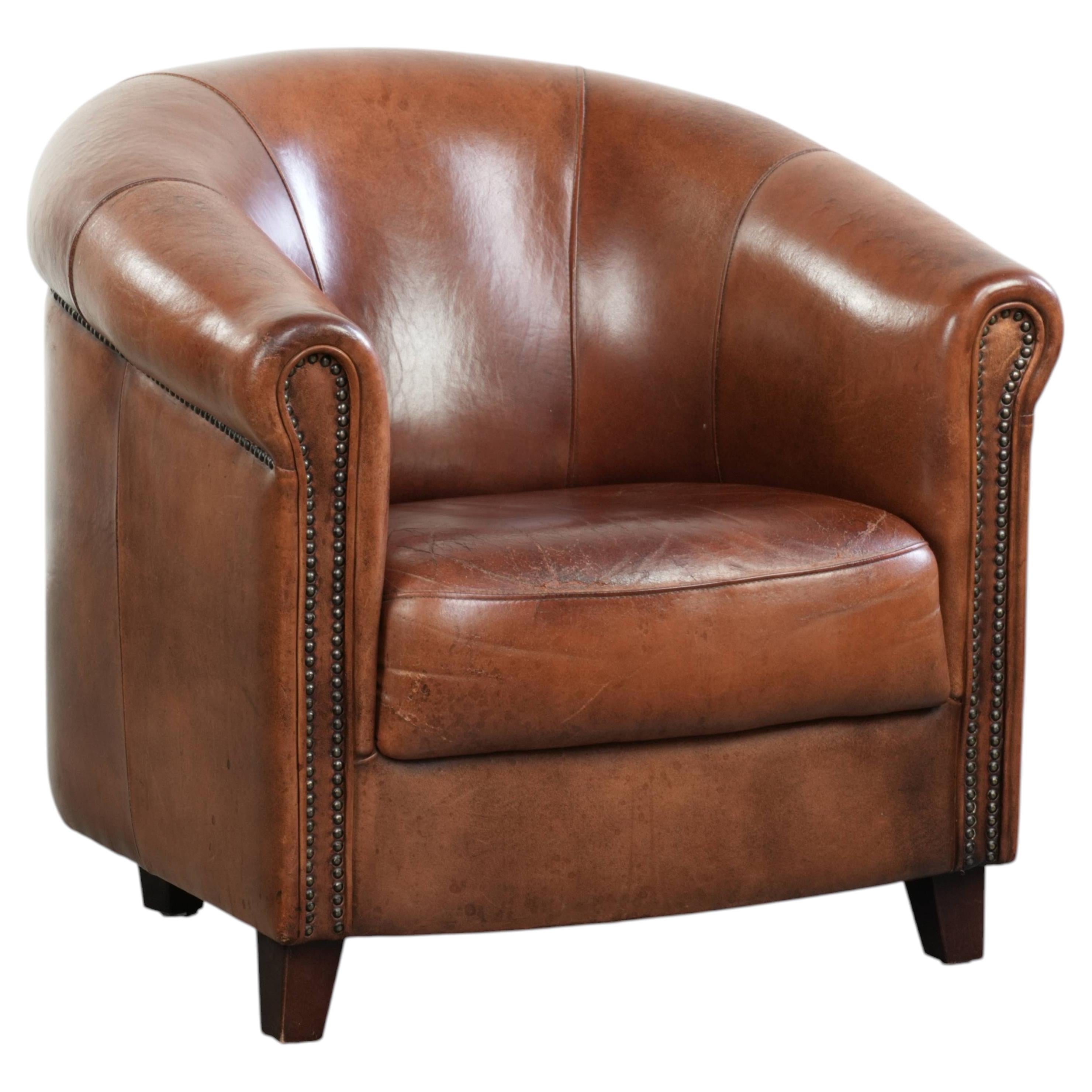 Vintage sheepskin club armchair in English style with deep colours