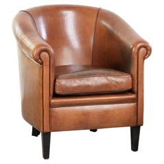 Vintage sheepskin club armchair with a warm colour scheme with black piping