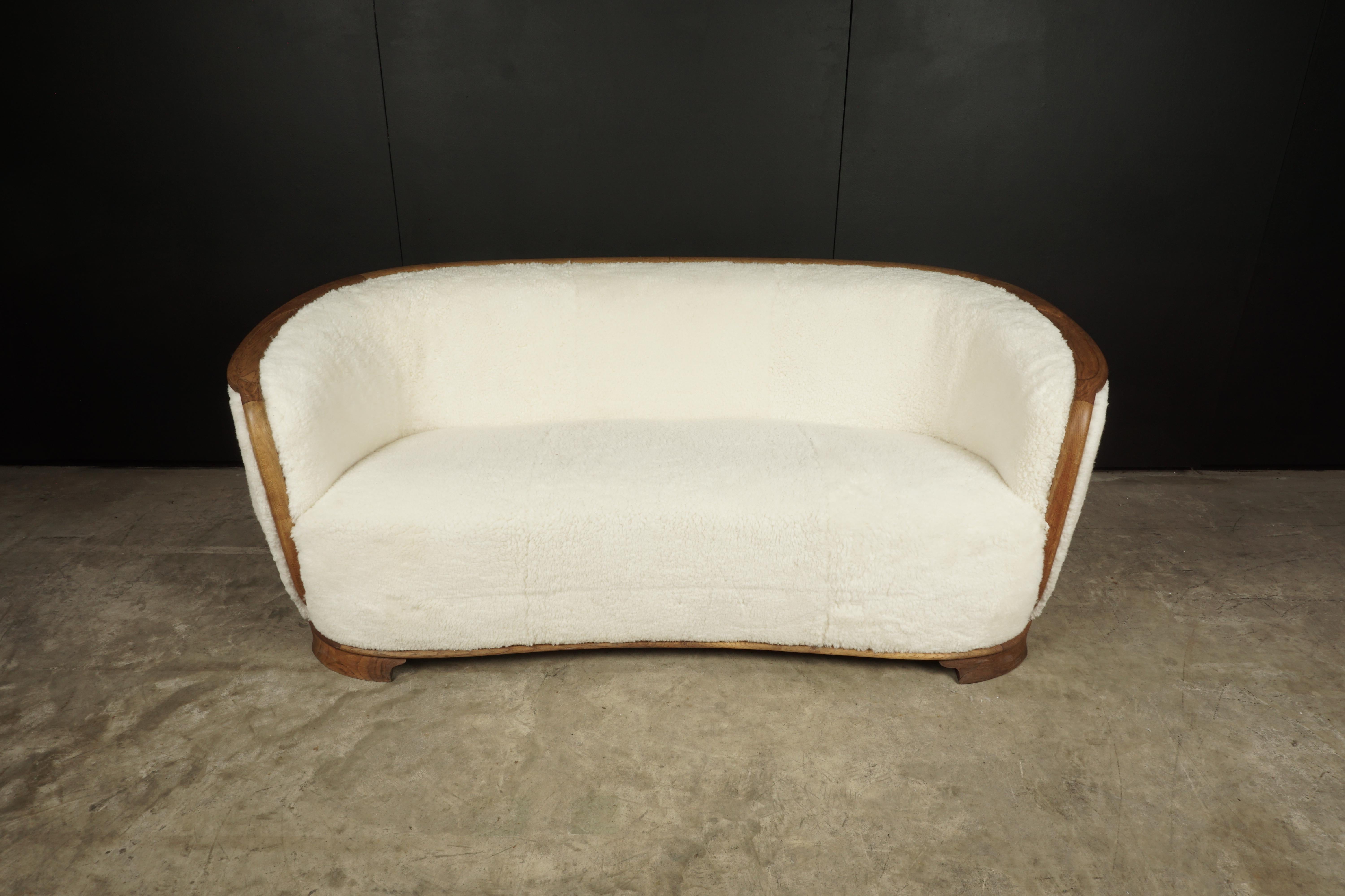 Rare Vintage Cabinet Maker Sofa in Sheepskin, Denmark, 1950s. Sofa with an oak edge and a slightly curved shape. Great condition and quality.